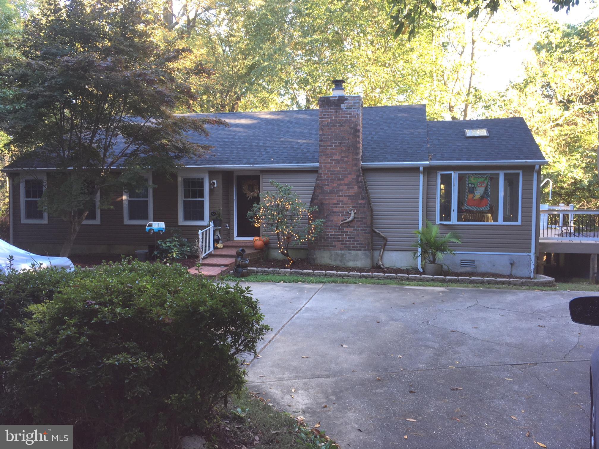 LIVE IN NATURE IN YOUR OWN PRIVATE OASIS! ONE FLOOR LIVING AMONG THE TREES W/UPDATES SINCE 2014: NEW ROOF,SIDING (UPGRADED INSULATION), NEW MAIN FL HARDWOOD, BLINDS,WINDOWS,MOST DOORS,PART OF DRIVEWAY,REMODELED REC.RM,800 SQ.FT. LIGHTED WOLF DECK,21' AG HEATED POOL, PAVER  PATIO/FIRE PIT,TIGER WOOD KIT COUNTERS,NEW MAIN BATH.LG DR W/NEW SLIDER TO DECK/POOL. JUST PLACE YOUR FURNITURE!