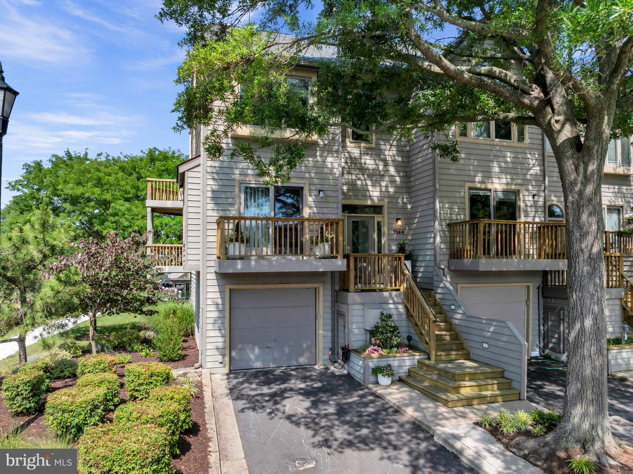 Welcome to 2144 Chesapeake Harbour Drive  a stunning end-unit townhome in the sought-after community of Chesapeake Harbour. Perfectly positioned to overlook the Chesapeake Harbour Marina and with Chesapeake Bay views, this move-in-ready home combines luxurious updates with an exceptional waterfront lifestyle.

The main level features a beautifully updated kitchen with marble countertops, stainless steel appliances, upgraded finishes and even a serene view of the Bay. The kitchen flows seamlessly into the dining area and spacious living room, where an electric fireplace creates a warm and inviting atmosphere. Sliding doors lead to a private deck overlooking the marina, providing the perfect place to enjoy your morning coffee or unwind at sunset. A convenient half bathroom completes this level.

Upstairs, the spacious primary suite offers a walk-in closet and a beautifully renovated private bathroom with a walk-in shower. A second bedroom, a fully updated hall bathroom, and an upper-level laundry area complete this floor. The top level features a private third bedroom with separate aircon unit, creating an ideal space for guests, a home office, or whatever best fits your needs.

The walkout lower level provides even more flexible living space with a cozy family room featuring a wood-burning fireplace and access to a private patio with marina views.  There is also a wet-bar with wine cooler, making this room perfect for entertaining.  The attached garage has been enhanced with custom epoxy flooring and built-in storage cabinets, creating a polished and functional space.

Nearly every inch of this home has been thoughtfully updated in recent years, including new Marvin windows and sliding doors, custom window coverings, luxury vinyl plank flooring, custom stair railings, marble kitchen countertops, beautifully renovated bathrooms, new lighting fixtures, and a new LG washer and dryer. The roof was replaced in 2025, and the community is completing fresh exterior painting this year, adding even more value and curb appeal.

Chesapeake Harbour offers an unmatched amenity package, including an outdoor pool with water views, tennis and pickleball courts, a private beach, and beautifully maintained common grounds. Residents also enjoy plenty of parking for both owners and guests. Just moments away, you'll find local favorites such as Beacon Waterfront Galley & Bar, the Annapolis Maritime Museum, Black Market Bakers, nearby parks, shopping, dining, and easy commuter access.

If you've been dreaming of a low-maintenance waterfront lifestyle with breathtaking views, resort-style amenities, and designer finishes throughout, this exceptional home is one you won't want to miss. Schedule your private tour today!