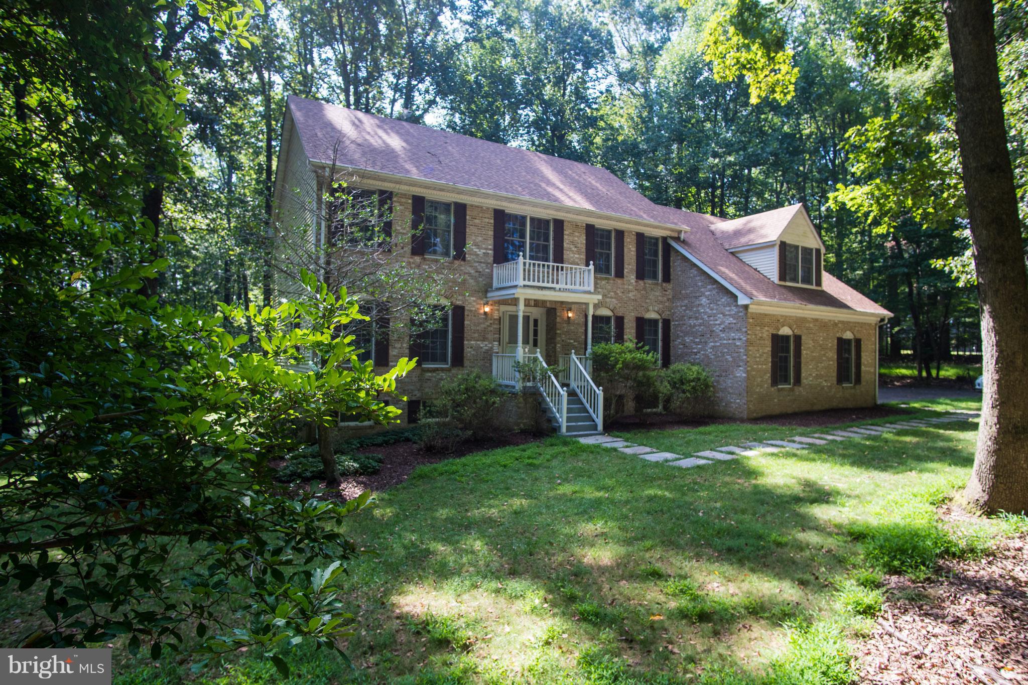 Open Sun 1-3. Beautiful and spacious brick home with tons of privacy on almost 4 acres! Featuring 3 lvls with 4 bedrooms, 2.5 baths and a 2 car, oversized garage. Well maintained hardwood floors on main level & brand new carpet throughout the bedrooms. New paint, new roof, new SS appliances, updated Master BA, 3 closets in Master BR, Geothermal Furnace, 2 heating zones, tons of parking, No HOA