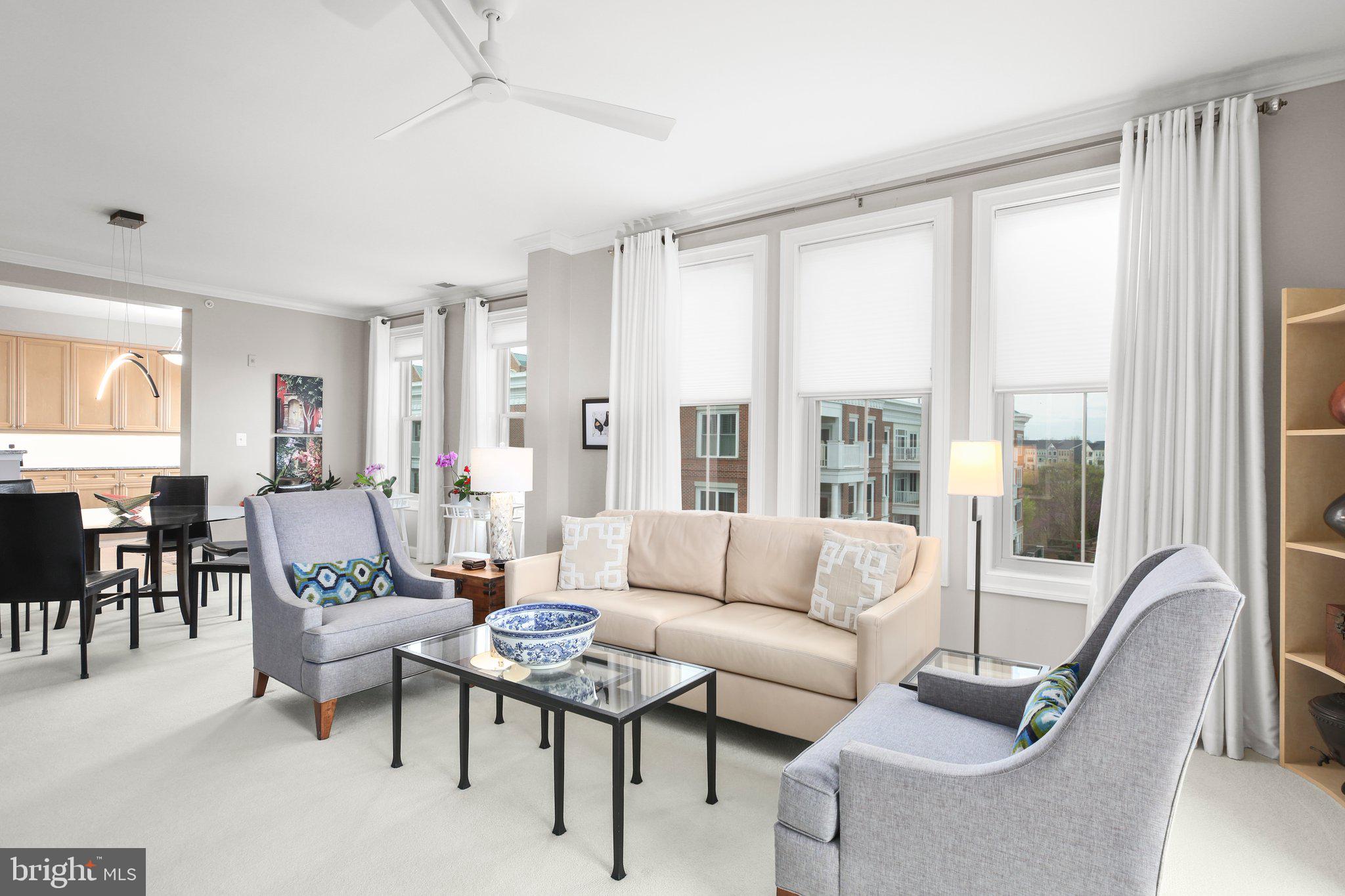 Welcome to this rarely available top floor condo in the beautiful Belmont Bay with direct water views! This 2-bedroom, 2-bath top-floor condo offers views of  boat activity along the bay, bird watching, and front row seats to all concerts held by the active social committee at the Pavilion. Inside, you’ll find a light-filled, beautifully maintained unit featuring neutral paint throughout and updates galore. The open concept leads to the chef's kitchen with wood cabinetry, granite countertops, stainless steel appliances and decorative tile backsplash. The living area offers crown molding, updated lighting and a cozy fireplace with built ins. Into the primary suite find a huge walk in closet and remodeled primary bathroom with dual vanity quartz countertops, frameless glass shower and large separate soaking tub. The additional bathroom has been updated to match the gorgeous tile of the primary suite.  Additional highlights include an in unit washer & dryer, two garage parking spaces and a private storage room conveniently located on the same floor. Tucked marina-side in a vibrant community with a pool, walking trails and an active social calendar and more, this is your opportunity to enjoy relaxed luxury with a view.