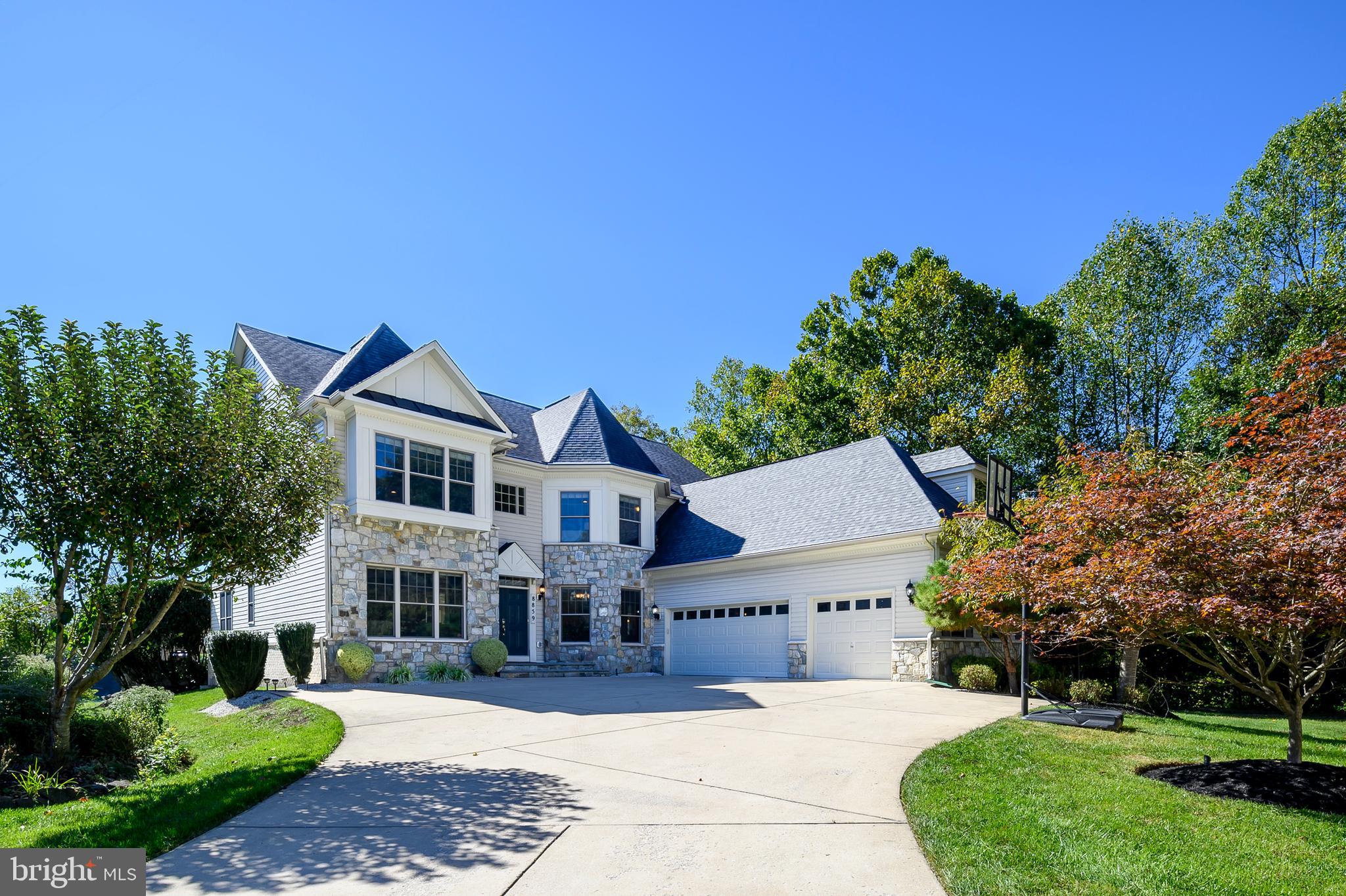 Welcome to 8859 Deep Water Lane! This breathtaking custom-built home is perfectly situated on a premium (water-view) lot in Howard County’s sought-after gated community of Stone Lake. From the moment you approach the property, it’s clear that this is no ordinary home. With unobstructed, panoramic views of Stone Lake, this residence offers an idyllic lifestyle with access to nature, luxury, and privacy, all within a secure, serene setting. The Stone Lake community is truly a retreat offering 24-hour security and a wealth of amenities catering to an active, outdoor lifestyle. Residents enjoy exclusive access to a beautiful 25-acre lake with a beach, boat house, and private boat slips. Fishing enthusiasts will love the stocked lake. There’s also a pavilion available to rent for private events, as well as walking and jogging paths, tennis and pickleball courts, baseball fields, practice putting green and playground. The HOA also takes care of grass-cutting and snow removal. The home is designed for both elegance and comfort, with 6,000+ finished square feet, six bedrooms, five and a half baths and three car garage. As you enter the home, you’ll be greeted by expansive lake views from nearly every room, with large windows that invite natural light and bring the outdoors in. The spacious family room features coffered ceilings, cozy fireplace and breathtaking views of the water beyond. Just off the family room is a large morning room, an ideal spot to start your day with a cup of coffee while soaking in the serene lakefront landscape. The chef’s kitchen features a large island, granite countertops, wall oven, gas cooktop with range hood, tile back splash and walk-in pantry. For more formal occasions, the elegant dining room sets the perfect stage for memorable meals. The main level also boasts a private library with custom shelves/cabinets, as well as a separate office, ideal for working from home. Upstairs, the primary suite is a true sanctuary, complete with a cozy sitting room with its own fireplace, a luxurious en-suite with soaking tub, walk-in dual head shower, dual vanities, and a large walk-in closet. The second bedroom has its own en-suite bath, while two additional bedrooms share the hall bathroom. The versatile fourth level loft is ideal for guests as it is complete with its own full bath. An upper-level laundry room adds convenience. The finished basement is an entertainer’s dream, complete with a full bar that includes a sink, refrigerator and wine fridge. The expansive recreation room features a fireplace, built-in speakers, and offers the perfect atmosphere for movie nights or game days. The sixth bedroom can function as an exercise room or an extra bedroom and is accompanied by a full bath for convenience. There’s also a large storage space for seasonal items. The home boasts a $17,000 indoor music system on the main and lower level as well as the exterior, complete with pre-wired touchscreen room controls, allowing you to enjoy music wherever you see fit. The dual-zone HVAC system, installed in 2022, ensures year-round comfort. Additional features include gutter guards, a security system with motion detectors and pet identifiers, and tech-ready pre-wired outlets in key rooms. Stepping outside, you’ll find a remarkable outdoor living space overlooking Stone Lake. The owners spent $150,000 building the two-level stone patio, which spans over 1500 square feet and features a fire pit, outdoor kitchen with a Twin Eagle grill and skillet, refrigerator, TV, and built-in speakers—perfect for entertaining or relaxing. This home blends luxury, comfort, and functionality, offering everything you need to enjoy life at its fullest. Located in a premier community with top-tier amenities and steps away from the beauty of Stone Lake, it’s truly a one-of-a-kind property. Don’t miss your chance to own this wonderful home!