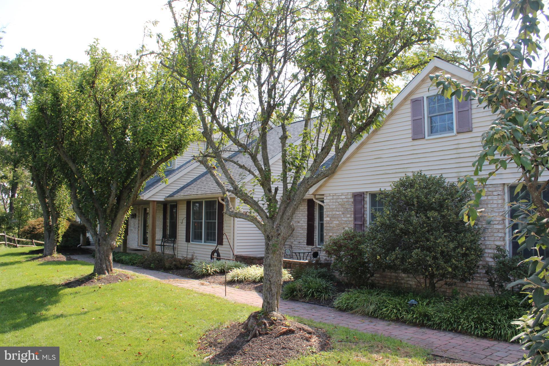 Wonderful custom home, secluded but just minutes from Boyertown, nestled on 14.05-acre parcel w/wooded & open areas offering cut hiking trails and plenty of hunting space. At just over 3,100 hundred square ft this home offers four spacious bedrooms, 3.5 bathrooms and a first-floor master bedroom.  Entering the home, you'll be greeted the naturally flowing floor plan and beautiful hardwood flooring that flow directly to the great room w/full wall natural wood burning brick fireplace. The great room is basked in natural light by double sliders providing access to screened patio entertaining and outdoor dining area. Spacious eat-in kitchen w/solid Oak cabinetry, Corian counters, breakfast bar & SS appliances.  The D/R flows naturally form kitchen and is basked in natural light, hardwood flooring   throughout the first floor and open floor plan all add to the beauty of the home. First floor office, laundry w/egress, powder room and access to oversized three car (3) attached garage.  Enjoy carefree one floor living at its finest w/floor master bedroom w/ in-suite bath, spacious walk-in closet, private master deck and family room.  (Also, could be used as in-law suite.) Additionally located on the first floor you will find large second bedroom and full bathroom.  Solid Oak stairs lead to the second floor of this beautiful home and large third and fourth bedrooms, full bath and very large walk-in closet and attic. The lower-level unfinished basement is just waiting to be finished and could add additional 1.500 plus square ft of living and storage space. Other amenities include central air, double 200-amp electric service, above ground pool, yard shed, covered wood storage. Freshly paved driveway and parking area.  Centrally located, minutes from schools, shopping, and major arteries.  Property is in clean and green tax plan. Easy access to Reading, Allentown, this wonderful home offers seclusion, privacy, and convenience.
