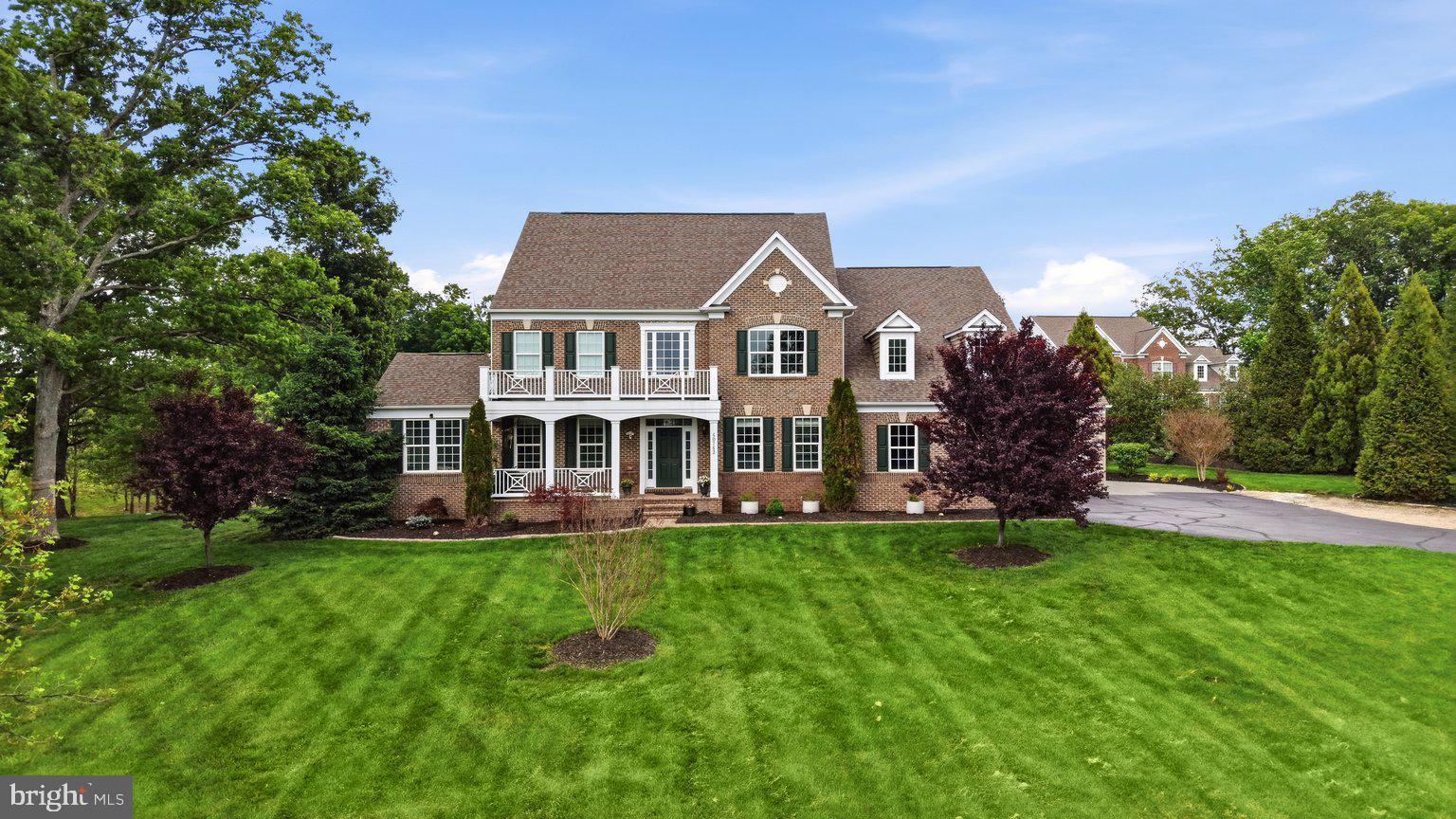 Welcome to this spectacular custom estate tucked within the prestigious Huntleigh at Creighton Farms community, where luxury, privacy, and modern functionality converge on over 4 breathtaking acres surrounded by mature trees and expansive green space. Offering more than 7,200 square feet across four beautifully finished levels, this exceptional residence has been extensively upgraded with over $250,000 in recent improvements, creating a home that lives and feels like a newly customized luxury estate while offering the warmth, elegance, and flexibility today’s luxury buyers desire.

Featuring 7 spacious bedrooms and 6.5 baths thoughtfully distributed across all four finished levels, this extraordinary home was intentionally designed for multigenerational living, long-term guests, au pair accommodations, or evolving family needs. Highlights include a main-level in-law suite with handicap-accessible doorways and private comfort features, a private fourth-level bonus retreat with separate HVAC system, and expansive living areas that provide both privacy and connection throughout the home.

The beautifully remodeled 2025 gourmet kitchen serves as the heart of the home, showcasing stunning countertops and backsplashes, custom cabinetry, oversized center island, designer coffee bar, and newly installed luxury Sub-Zero refrigerator and Wolf gas cooktop. The sun-filled breakfast room overlooks the beautifully landscaped grounds, while elegant entertaining spaces include a formal dining room with butler’s pantry, expansive family and living areas, a striking stone gas fireplace, and walls of windows that flood the home with natural light and picturesque views.

The luxurious owner’s suite offers a true private retreat with a spa-inspired bath and dual walk-in closets, while the upper level also features generously sized secondary bedrooms and a spacious laundry room with additional storage. Bathrooms throughout the home have been tastefully upgraded with quartz-top vanities, modern fixtures and mirrors, beautiful new tile work, updated porcelain flooring, fresh paint, updated lighting and fixtures, and premium Karastan high-traffic carpet throughout.

The walk-up lower level offers exceptional flexibility for modern luxury living and features expansive recreation and media areas, exercise and hobby rooms, abundant storage, and a brand-new grand full second kitchen — ideal for multigenerational living, private guest quarters, extended stays, or elevated entertaining.

Step outside to your own private resort featuring over $150,000 in thoughtfully curated landscaping and hardscaping improvements, including more than 3,000 square feet of custom patio space, a fire pit lounge, oversized hot tub, sprinkler system with booster pump, permeable parking extension, newly sealed asphalt driveway, and beautifully designed outdoor gathering areas perfect for entertaining, relaxing evenings under the stars, or enjoying the peaceful natural surroundings.

Additional luxury and infrastructure improvements include full-home spray foam insulation, whole-house RainSoft water filtration and softener system, upgraded electrical power in the garage and basement, an owned 1,000-gallon propane tank, and a whole-house Generac generator for added peace of mind. The home also benefits from multiple HVAC systems, including separate climate control servicing the in-law suite and upper-level bonus retreat, providing enhanced comfort and efficiency throughout. The main HVAC servicing the basement, main level, and upper floor was upgraded to the Performance Series in 2021, while all HVAC systems and heat pumps were professionally serviced in 2025.

The oversized 3-car garage, extended parking areas, and extensive recent improvements further elevate this exceptional offering.

A rare opportunity to own an extensively upgraded luxury estate offering timeless elegance, modern infrastructure, multigenerational flexibility, and resort-style living just minutes from