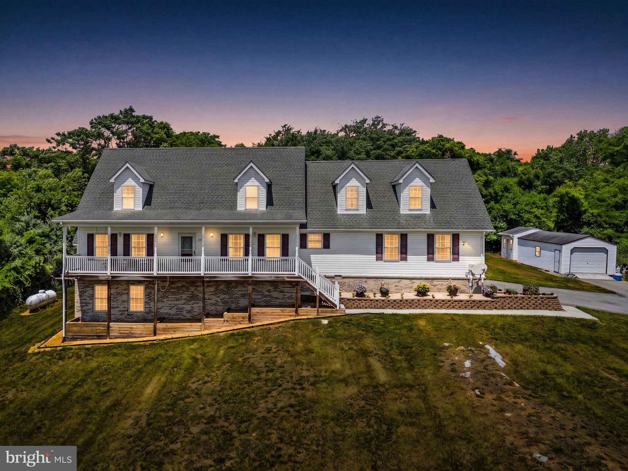 Welcome to 253 Sylvan Springs Drive in Clear Brook, VA—a beautiful Cape Cod situated on a 
hilltop among 5 private acres, offering the perfect blend of space, comfort, and convenience! 
This well-maintained home features 5 bedrooms and 3.5 bathrooms, including two primary 
suites - one on the main level - making it ideal for multi-generational living or guests. There is 
plenty of room with nearly 2,800 square feet of living space above ground, plus a fun-filled 
basement. 
The interior offers a 2-story foyer, hardwood and Vinyl flooring, and a spacious layout 
designed for real life. The main-level living room, currently used as an office, features a gas 
fireplace, built-ins, and crown molding, while the adjoining family room has a cozy electric 
fireplace that conveys with the home. The kitchen features updated appliances including a new 
electric range, dishwasher, and built-in microwave (Feb 2026), complemented by a side-by-side 
refrigerator with bottom drawers and icemaker (2019), an island, and a breakfast bar. The main-
level primary suite boasts new carpet (2022), a ceiling fan, and a deluxe bath with dual sinks, a 
jetted tub, a separate shower, and tranquil treed views.
Upstairs, there’s a second primary suite with a walk-in closet and private full bathroom. Three 
additional bedrooms and another full bathroom provide plenty of room for family, guests, or a 
home office setup, especially with the oversized 5th bedroom.
The basement is ready for game nights and entertainment with a pool table (accessories 
included) and a movie room with a motorized 150" screen (available for separate purchase). 
The utility room offers extra storage with a newer water heater (2019), well water tank, and 
water softener.
Outside, enjoy peaceful mornings on the covered front porch or entertain on the rear deck 
overlooking the scenic, wooded property. The attached 2-car side-load garage comes loaded 
with built-in shelving, cabinets, and workbenches, plus a freezer and refrigerator that convey. 
(A rarely-used, gas-powered Generac GP17500E generator is available for separate purchase.)
Two additional outbuildings: a fully electric shed with its own subpanel, welder-ready wiring, 
and garage entrance, plus a second shed with carpet, a ceiling fan, and a window A/C unit -
ideal as a studio, workshop, or retreat.
Starlink or DirecTV are available for internet, and fiber has recently been installed on the street. 
The well is 600’ deep and the septic field was pumped in 2024. There's plenty of room for 
gardening, recreation, or simply enjoying the privacy of country living - yet you're just minutes 
from Winchester, I-81, shopping, dining, and schools. This is a rare opportunity to own your 
own slice of Virginia countryside with no HOA