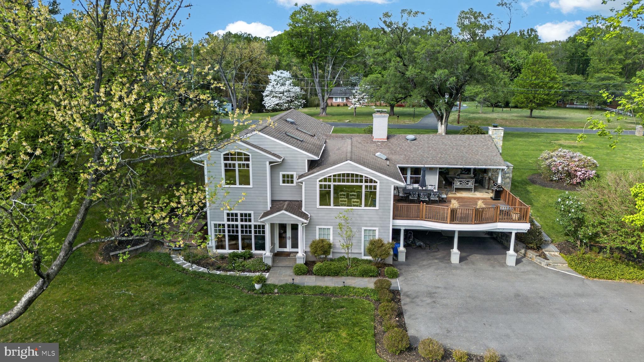 This exceptional, sun-filled private estate offers 6 bedrooms, 3.5 baths on nearly 1.4 beautifully landscaped acres overlooking a wooded ravine, seamlessly blending timeless mid-century craftsmanship with a thoughtfully designed modern expansion. Originally built in 1956 with remarkable quality and character, the home preserves its original hardwood floors and classic tilework while incorporating extensive high-end renovations throughout, creating a rare combination of warmth, luxury, functionality, and architectural distinction.

Designed for long-term livability, the home provides convenient ground-level access from both the front entrance and terrace level to the main living area. A significant 2004 addition introduced dramatic floor-to-ceiling windows overlooking the park-like backyard, radiant heated floors, and hydronic baseboard heating, creating a comfortable and energy-efficient living environment year-round.

At the heart of the home is a spectacular chef's kitchen featuring an 8-burner gas range, double Wolf ovens, a paneled GE Monogram refrigerator, Cove dishwasher, Omega Dynasty custom cabinetry, granite countertops, a custom natural stone hearth, and radiant heated tile floors. The kitchen flows effortlessly into the surrounding living and dining spaces, all framed by breathtaking views of the private backyard and wooded ravine.

Filled with natural light, the adjoining living and dining areas are designed for both comfortable everyday living and effortless entertaining. Step outside to the expansive 25' x 30' Ipe wood deck and covered patio, highlighted by a handcrafted, Italian-inspired natural stone pizza oven with a dramatic 9-foot floor-to-ceiling stone chimney, creating an exceptional setting for outdoor dining, entertaining, and year-round enjoyment.

The upper level features three spacious bedrooms and two beautifully renovated baths. The luxurious primary suite offers a spa-inspired bath and two custom Elfa-designed walk-in closets. A second bedroom enjoys access to an updated full bath, while the third bedroom—with picturesque wooded views—also serves beautifully as a home office and includes a generous walk-in closet. Scenic views of the private backyard and wooded ravine can be enjoyed from the upper-level bedrooms, while rich hardwood floors, solid wood plantation shutters, and custom architectural details—including a hand-welded staircase railing paired with Brazilian cherry stairs—further enhance the home's timeless appeal.

The walkout lower level offers three additional bedrooms, one full bath, one half bath, and a spacious family room featuring radiant heated designer tile floors, a propane fireplace, and tranquil views of the surrounding landscape. This versatile level also includes a renovated full bath, a large utility room with full-size washer and dryer, abundant storage, and direct access to the garage.

Additional highlights include Weather Shield windows (2021), a four-zone air conditioning system, hydronic oil-fired heating, a water heater replaced in 2024, a custom mahogany front door, premium plantation shutters, two skylights, extensive storage throughout, and professionally landscaped grounds complete with a picturesque hill that's perfect for winter sledding.

Offering exceptional craftsmanship, luxurious modern comfort, and extraordinary natural beauty, this one-of-a-kind estate provides a peaceful retreat while remaining just minutes from everyday conveniences.