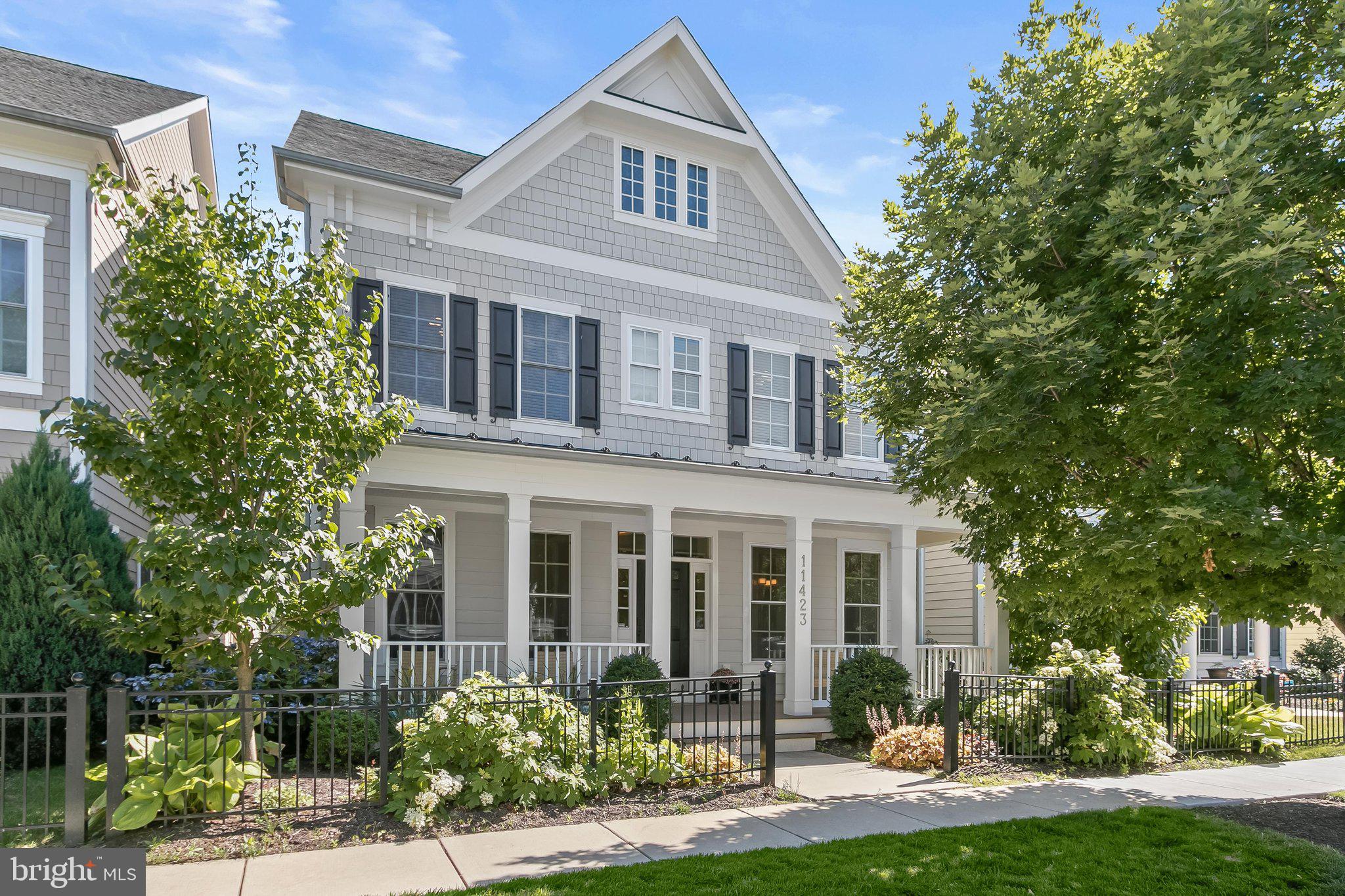 Welcome to 11423 Ellington Street in Maple Lawn, Howard County's most coveted community. Crafted by renowned builder Michael Harris Homes, this Bristol model is located on one of the Midtown-West District's quietest streets and announces itself with a striking full-width front porch and attached garage. Step inside to rich hardwood floors that flow seamlessly across the entire main level. At the front of the home, a formal living room and dining room are appointed with three-piece crown moulding, chair rail, and box moulding, all bathed in natural light through four windows — a sought-after builder upgrade. The dining room connects effortlessly to the kitchen via a well-appointed butler's pantry, complete with a prep sink and ample upper and lower cabinetry. The heart of the home is a chef's kitchen featuring white shaker-style cabinetry, granite countertops, and a top-of-the-line appliance package. It opens to a bright eat-in area and a stunning family room with coffered ceilings, a gas fireplace, and a wall of windows. A large private office with French doors, a guest coat closet, a mudroom, and a half-bath complete this thoughtfully designed level.

Upstairs, luxury vinyl plank flooring extends through the hallways and all bedrooms. The primary suite is a true retreat, offering a trey ceiling, a serene sitting room bump-out, and three generous walk-in closets. The spa-inspired primary bath features a dual-sink vanity with marble countertops, a large frameless shower, and a soaking tub. Three additional secondary bedrooms share a beautifully finished bath with a white shaker-style dual-sink vanity. A dedicated laundry closet and linen closet complete the upper level. The finished lower level expands the home's living space with a spacious recreation room, a full bathroom, and two unfinished areas ready for storage or future 5th bedroom customization. Conveniently located close to all major Baltimore/DC commuter routes and with enviable amenities including a resort-style community pool, tennis courts, pickleball courts, basketball courts, walking trails, and a state-of-the-art gym — you’ll quickly see why Maple Lawn is an award-winning planned community unlike any other in the region.
