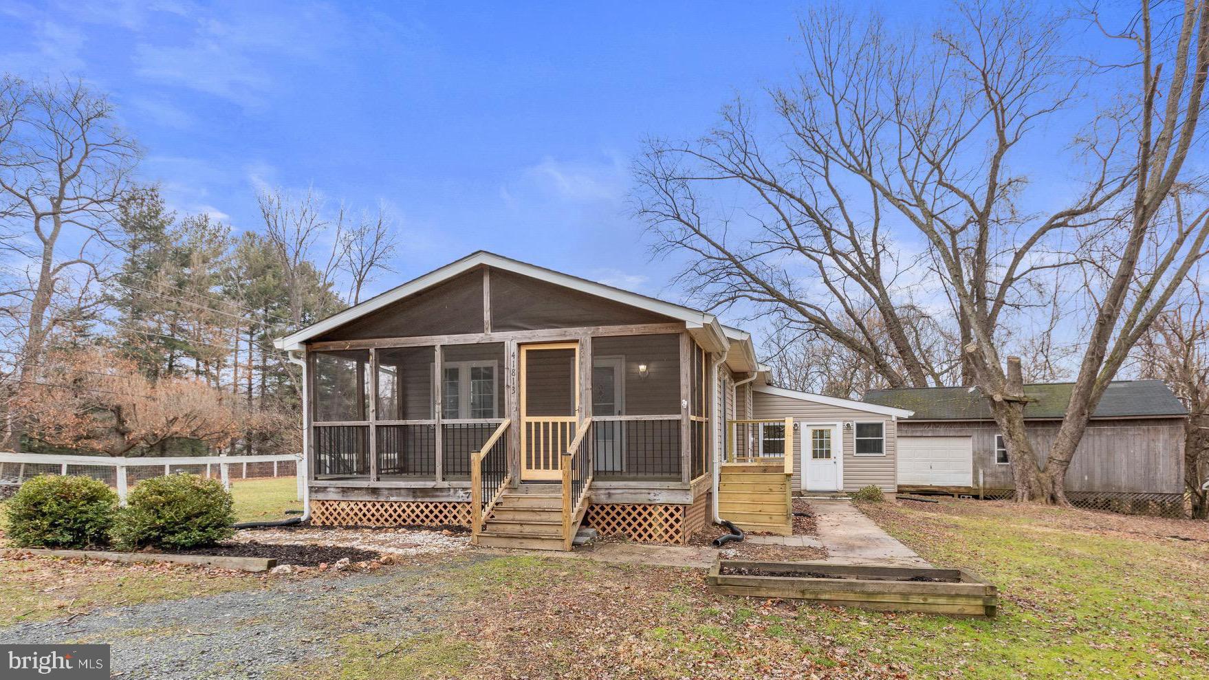 Rare opportunity to own a move-in-ready house in Loudoun Co. for less than the cost of most townhouses, and no HOA! Located near the Lucketts community of north Leesburg, this 2,016 finished sq.ft., 2-bedroom, 2-bath house with a fully-finished basement sits on almost 1/2 acre, tucked quietly behind the neighboring house and backing to woods.  Numerous recent updates, renovations, and improvements include HVAC system installed in 2017, fully-updated basement bathroom with walk-in shower, painting and drywall improvements to a basement bonus room with a large walk-in closet (used as a spacious THIRD BEDROOM by current owners), sump pump and underdrain added in basement, new washer and dryer. Kitchen fully renovated with refinished/painted cabinets, granite countertops, LVT flooring, and all-new stainless-steel appliances (2022), NEW ROOF with gutters and gutter guards (2021) and a new well pump installed to the private well (2021).  Besides the spacious living room and basement rec. room with a built-in bar, there is also a sizable "sunroom" for added living space/bonus room that exits to the side yard.  The exterior also features a new side landing and stairs (2023) leading from the living room sliding glass door down to the private side yard with a fire pit, shaded by mature hardwood trees and frequented almost daily by deer and other wildlife.  Screened-in front porch provides an excellent space for outdoor dining, or enjoying the breeze, watching fireflies and listening to cicadas on warm Summer nights without the nuisance of mosquitos.  The backyard holds a 2nd deck and a large barn-sized storage shed.  The driveway is shared with the neighboring house on a permanent deeded easement and provides ample parking for 4+ cars right in front of the home.  Private, peaceful and rural, yet only minutes away from downtown Leesburg, major shopping centers, major roads (US-15, VA-7, VA-9, Toll Road) and numerous wineries, breweries, and farm stands.  Also, less than 7 miles from the Maryland border and the MARC commuter train station.  Already wired for Verizon FIOS high-speed cable/internet.  Convenient country living at its best!