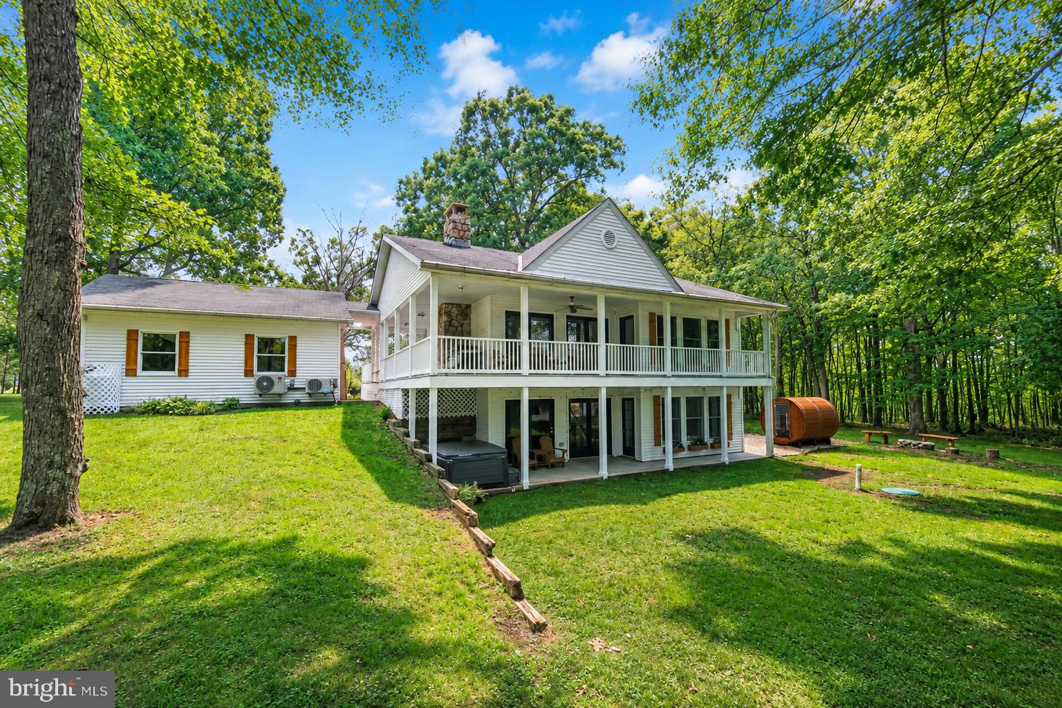 Wake up to breathtaking views of Deep Creek Lake every single day from this beautifully updated 3-bedroom home, complete with private lake access in a quiet, peaceful cove. Huge windows throughout invite in an abundance of natural light while framing the surrounding scenery, blurring the line between indoors and out. The open-concept kitchen features beautiful new quartz countertops and flows seamlessly into the living space, creating the perfect spot to entertain or simply relax while soaking in the views. Step outside onto the oversized wrap-around deck — an entertainer's dream and the ideal place to sip your morning coffee or wind down during sunset.  A private barrel sauna and hot tub provide the ultimate way to unwind after a day on the water or the slopes, all while a detached two-car garage offers plenty of storage for your lake-life gear. Efficiency is highlighted with multiple heating and cooling zones throughout the home. A new homeowner will enjoy the luxury of high-end appliances and laundry rooms on each floor. This is truly the ideal four-season home: warm up by the cozy pellet stove on chilly winter nights, then soak up the sun and dive into all the lake activities summer has to offer, including kayaking, canoeing, swimming, and fishing right from your private community lake access. With its unbeatable combination of views, natural light, and resort-style relaxation, this home is perfect as a full-time residence or vacation retreat. Don't miss your chance to own a piece of Deep Creek Lake paradise. Call today for more details or to schedule your private tour!