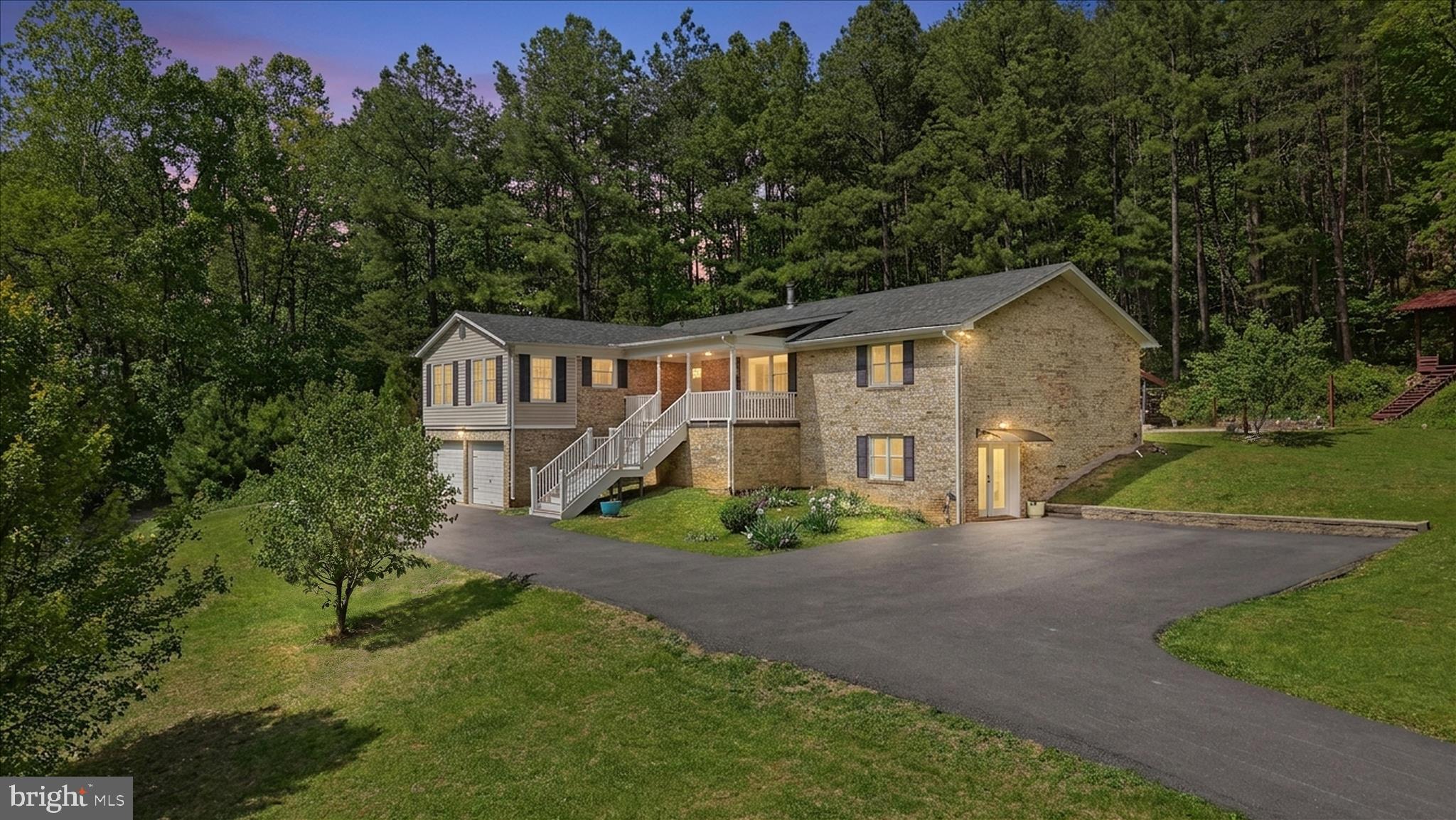 Welcome to this beautifully remodeled all-brick rambler offering 5 bedrooms, 3 full baths, and 3,896 square feet of living space. Situated on 5.6 acres bordering Shenandoah National Park, this exceptional property offers a rare combination of luxury, privacy, and natural beauty.

This home is filled with impressive features, including a newly built, expanded circular asphalt driveway, a spacious storage room connected to the 2-car garage, spacious living areas, modern updated finishes, and breathtaking views right from your doorstep. Step outside and enjoy your own backyard retreat with a stone patio, pavilion, and beautifully landscaped garden.

Whether you are seeking peace and tranquility or outdoor adventure, this property offers the perfect setting. The ground-level apartment provides an excellent opportunity for an in-law suite or an Airbnb rental for hikers and travelers. It features a separate entrance, full kitchen, and laundry room for added convenience and flexibility.

A detailed remodeling sheet is available in the documents section for your reference and highlights the extensive improvements made to this remarkable home.

Come experience the beauty, value, and endless possibilities this exceptional property has to offer.