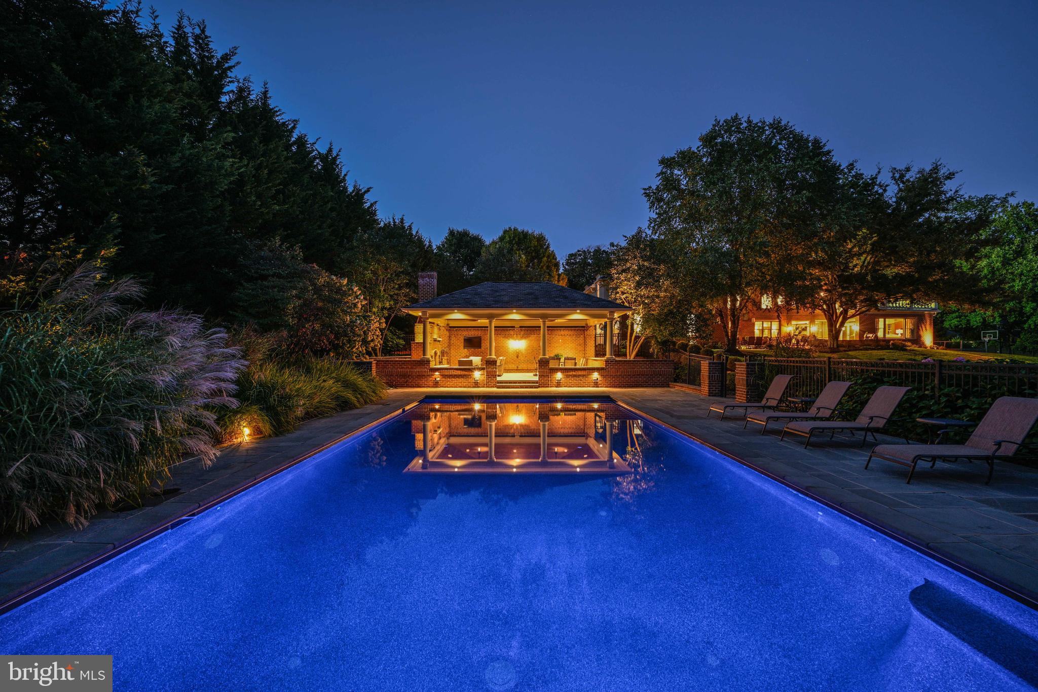 Live authentically. Set gently within a coveted geographic hub, tucked away,  surrounded by mature woodlands you are truly away from it all while being just where you want to be. Welcome to, an enduring architectural masterpiece.  Each day, as you approach this magnificent brick Georgian estate, you anticipate the sheer sense of joy of pulling into your private oasis, a sanctuary of opulence and serenity.

The property unfolds with a sense of pure outdoor living magic. A grand bluestone terrace, meticulously designed for graceful living, beckons you to explore its expanse. It leads you to the pièce de résistance: a stellar pool and outdoor pavilion. Here, as the sun dips below the horizon, a roaring fireplace and an outdoor TV set the stage for fall evening games and intimate gatherings, where a glass of wine by the fire becomes a ritual of relaxation and joy. The pool invites you to swim laps, to invigorate your physical form, and to immerse yourself in the soothing embrace of aqua-blue waters.

Beyond the pavilion, the expansive grounds offer a sublime level of privacy, enhancing all your backyard visions. Whether it's sports or the simple pleasure of birdwatching, this sanctuary provides a canvas for your desires. As you revel in the ever-changing sky, each day becomes a new masterpiece painted with nature's brush.

Descending to the lower level, you'll find yourself dazzled by its offerings. A private theater awaits your cinematic adventures, a well-appointed fitness center invites you to nurture your well-being, and a poker room sets the stage for evenings of friendly competition and laughter.

Throughout this estate, spacious proportions and generous flow define the living spaces. Long sightlines draw your eye gracefully from room to room, creating an ambiance of grandeur that seamlessly intertwines with the comfort of everyday life.

The incredible mudroom, designed with meticulous attention to detail, serves as the organizational hub for everyone, bringing both functionality and style to daily routines.

The owners' suite exudes a boutique hotel getaway aesthetic that is palpable from the moment you step inside. Here, welcome is a sensory experience of calm and restfulness, a retreat within a retreat.

For those who relish a spirited game of hoops, a private basketball court keeps family and friends ready for a friendly match before dinner, fostering a sense of camaraderie and joy.

The lifestyle you have been seeking is not a distant dream; it is right here, right now, in this grand and welcoming estate. It's a place where luxury, privacy, and leisure converge to create an unparalleled living experience, where each day is an invitation to embrace the best life has to offer. 
The windows will be replaced in the living room, dining room, family room, 2nd story foyer, master bath picture window, the service entry window, all the bedrooms, except the primary suite, whose windows have already been replaced. They are being replaced with  Marvin top-of-the-line windows.
Cultivate your existence. Please book your appointment now.