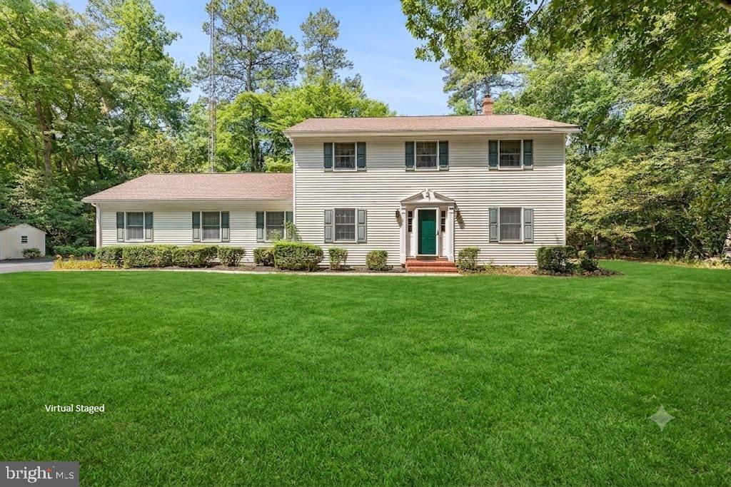 Nestled along a private road in a peaceful, tucked-away setting, this well-maintained Colonial offers the perfect blend of privacy, space, and convenience. Situated on more than 1.2 acres, the property backs to mature woods, providing beautiful wooded views and a serene backdrop to everyday living. The home needs only minor cosmetic updates, making it an excellent opportunity to add your own personal style. The main level offers an abundance of living space, including a welcoming eat-in kitchen, formal dining room, comfortable family room featuring a newer wood stove with a classic brick hearth, a separate living room, laundry room, and an expansive sunroom filled with natural light that opens to the private backyard setting. The upper level features three generously sized secondary bedrooms, a full hall bath, and a spacious primary suite with two closets and a private full bath. Outside, the property continues to impress with an oversized two-car garage offering plenty of room for vehicles, tools, and additional storage. An expansive paved parking area easily accommodates multiple vehicles, an RV, boat, or trailer. A patio and hot tub provide the perfect place to relax while enjoying the peaceful surroundings. Located just down the road from the Caroline County Country Club, offering golf and waterfront access along the Choptank River, this home is also just minutes from historic downtown Denton, where you'll find shopping, dining, and local entertainment. With convenient access to Routes 404 and 50, commuting to the Chesapeake Bay Bridge, Easton, Annapolis, and the Delaware beaches is easy, making this an ideal location for both everyday living and weekend adventures.  Mortgage savings may be available for buyers of this listing.