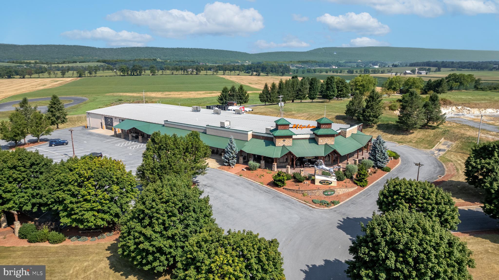 A visionary made this property a very successful business/commerical space now available for the next level of sucess!  This is the kind of property that doesn’t come along often.



Set on over 10 acres along State Route 322—one of the region’s busiest corridors—this high-exposure commercial/industrial site is built to elevate your business and make a statement while doing it in this 30,000+ sqft building. 



From the moment you step inside, the 11,000+ sqft showroom delivers a true “wow” factor. Expansive, open, and clean, it features soaring ceilings, a flexible layout, and a loft that overlooks the main floor—creating the perfect setting for showcasing products, hosting clients, or building a brand presence that stands out. Private offices, a welcoming reception area, and thoughtfully designed storage and support spaces make day-to-day operations seamless.



Behind the scenes, the property is just as impressive. A fully equipped service and repair area, pull-through garage with oversized access, and a functional warehouse with loading dock capabilities provide the infrastructure needed to run a high-level operation efficiently and effectively.



And then there’s the unexpected centerpiece—a stunning enclosed pavilion, handcrafted by Amish builders using exceptional materials. Complete with electric and a built-in stage, it opens the door for events, client experiences, team gatherings, or creative uses that set your business apart from the competition.



With unmatched visibility, room to grow, and a layout designed for both presentation and performance, this property is more than just a place to operate—it’s a place designed for success, a place to scale, to impress, and to win.