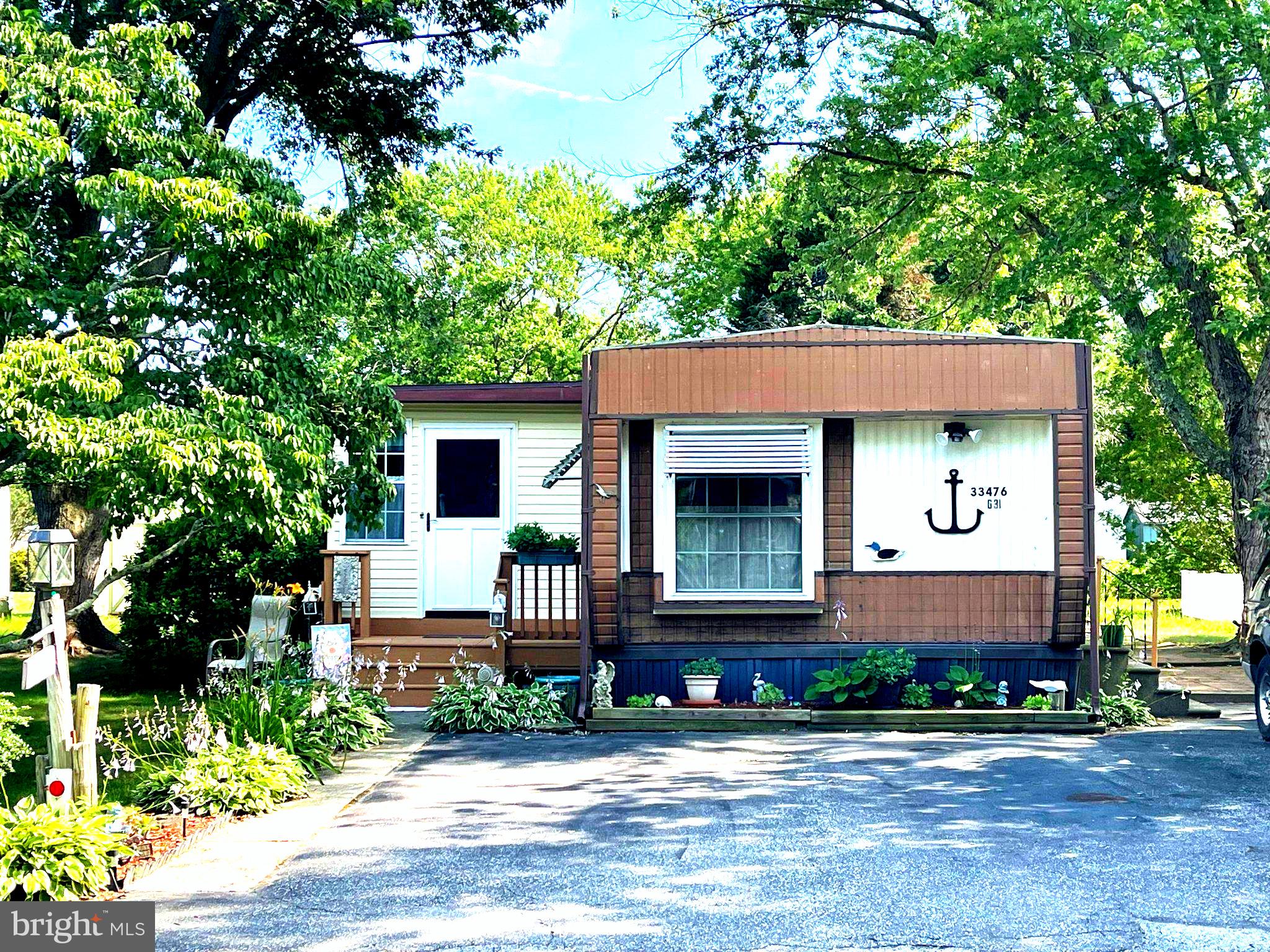 Discover this charming 2-bedroom, 2-bathroom in the desirable Angola Beach community in Lewes, close to all our beach area offers, great restaurants, shopping, beautiful state parks and more. Built in 1984, this well-maintained residence features a combination kitchen and dining area, full sized living room and an extra sitting area, perfect for entertaining and lots of room for overnight visitors. Enjoy the comfort of ceiling fans and the convenience of in-unit laundry with a washer and dryer included. The kitchen is equipped with essential appliances, including a newer gas oven/range, new refrigerator, and dishwasher. Step outside to relax on the deck or patio, ideal for outdoor gatherings. The community offers two refreshing pool for those warm summer days, two playgrounds, basketball Courts, boat dock/slip, common grounds, tennis courts and water/lake privileges.  With off-street parking for two vehicles and a shed for additional storage, this property combines functionality with comfort. Located in a beautiful area this home provides a perfect blend of tranquility and convenience. Experience the best of coastal living in Angola Beach!