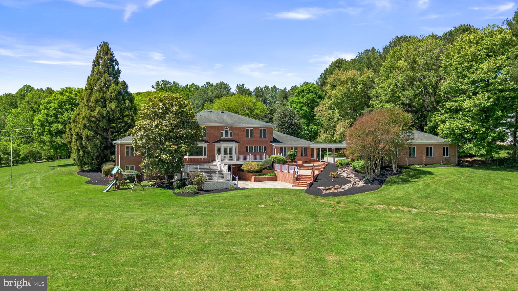95 Acres | 7,000+ sq ft of finished space | Five car garage | Two pole barns | Proudly introducing the Lewis Family Farm - Set on 94.27 acres of pristine pastureland, 6005 Ten Oaks Road stands as one of the final remaining legacy estates in the heart of Clarksville, Maryland. This extraordinary property embodies the region’s equestrian heritage, offering unmatched acreage, privacy, and potential in one of Howard County’s most coveted settings. With its combination of open fields, functional farm structures, and an elegant estate residence, this offering presents a once-in-a-lifetime opportunity to secure and shape a piece of Howard County history. The main residence spans approximately 7,000 finished square feet and was thoughtfully designed with timeless architectural elements and an inviting flow that lends itself to both everyday living and large-scale entertaining. The grand foyer, complete with a curved staircase and soaring ceilings, makes an immediate statement upon entry. To one side, a spacious formal dining room provides the perfect backdrop for hosting holidays and celebrations, while generous living and family spaces offer warmth and comfort enhanced by abundant natural light and scenic views. The home’s first-floor primary suite serves as a true retreat, featuring ample space for both rest and relaxation, while offering convenient access to the main living areas. Upstairs, additional bedrooms and flexible living spaces provide room for family and guests alike. The lower level includes a kitchenette and entertainment area, ideal for extended stays, gatherings, or potential guest quarters. While the home would benefit from thoughtful updates, its solid construction, scale, and flow make it an exceptional canvas for a discerning buyer to modernize and personalize. This property has hosted an extensive amount of large-scale events, family gatherings, and several weddings.  Outside, the property’s beauty unfolds across rolling pastures, multiple run-in sheds and stalls, and a large pole barn, creating a fully functional environment for equestrian pursuits or hobby farming. The property famously hosted twelve Ten Oaks Cup Polo matches over the years that drew in over 1,000 guests. The events successfully met the family’s fundraising goals for Our Daily Bread, a food kitchen in Baltimore where Mary Agnes served for decades. The five-car garage and circular driveway complement the estate’s stature, while the extensive hardscaping on the rear of the home provides an elegant setting for outdoor entertaining, relaxation, or simply enjoying panoramic views of the surrounding countryside. This is more than a property— it’s an opportunity to create a generational estate with endless potential for restoration, recreation, and refinement. Whether you envision a modern equestrian facility, a private sanctuary, or a showcase of fine country living, 6005 Ten Oaks Road offers the land, the legacy, and the location to make it a reality. A rare find in today’s market, this estate represents the final chapter of Clarksville’s grand pastoral properties—an invitation to preserve the past while crafting a visionary future in the heart of Howard County. Please reach out directly for details on equine features. **Important; this property is not subdividable - Buyers, please feel free to contact Joy Levy, Program Administrator, Howard County Agricultural Land Preservation Program (ALPP) for details on permissible uses.**