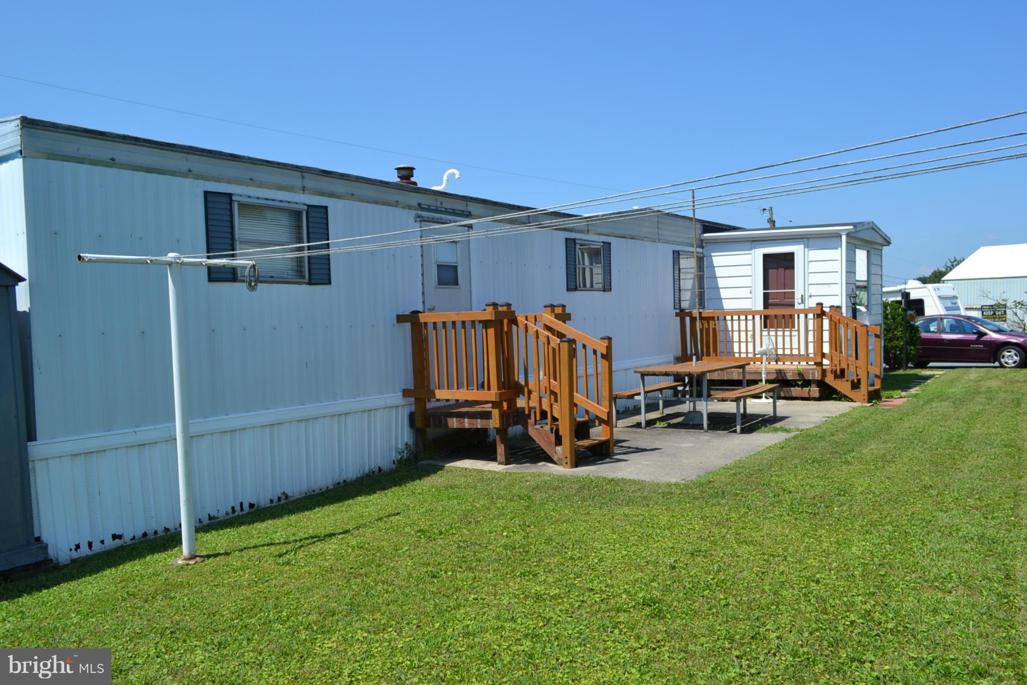 Older mobile home in small community park, original owner, well maintained. Original unit was 3 BR but now 2 and could easily be made back to 3. Unit is a 1970 with tip-out & 1 room addition. Nice deck + small porch. Eat-in kitchen.  Rubber roof on addition 5 years,furnace & CAC 5 years .Gas cook top (wall oven not working"as is").Park rent $400 monthly, includes water,sewer,taxes,trash removal.