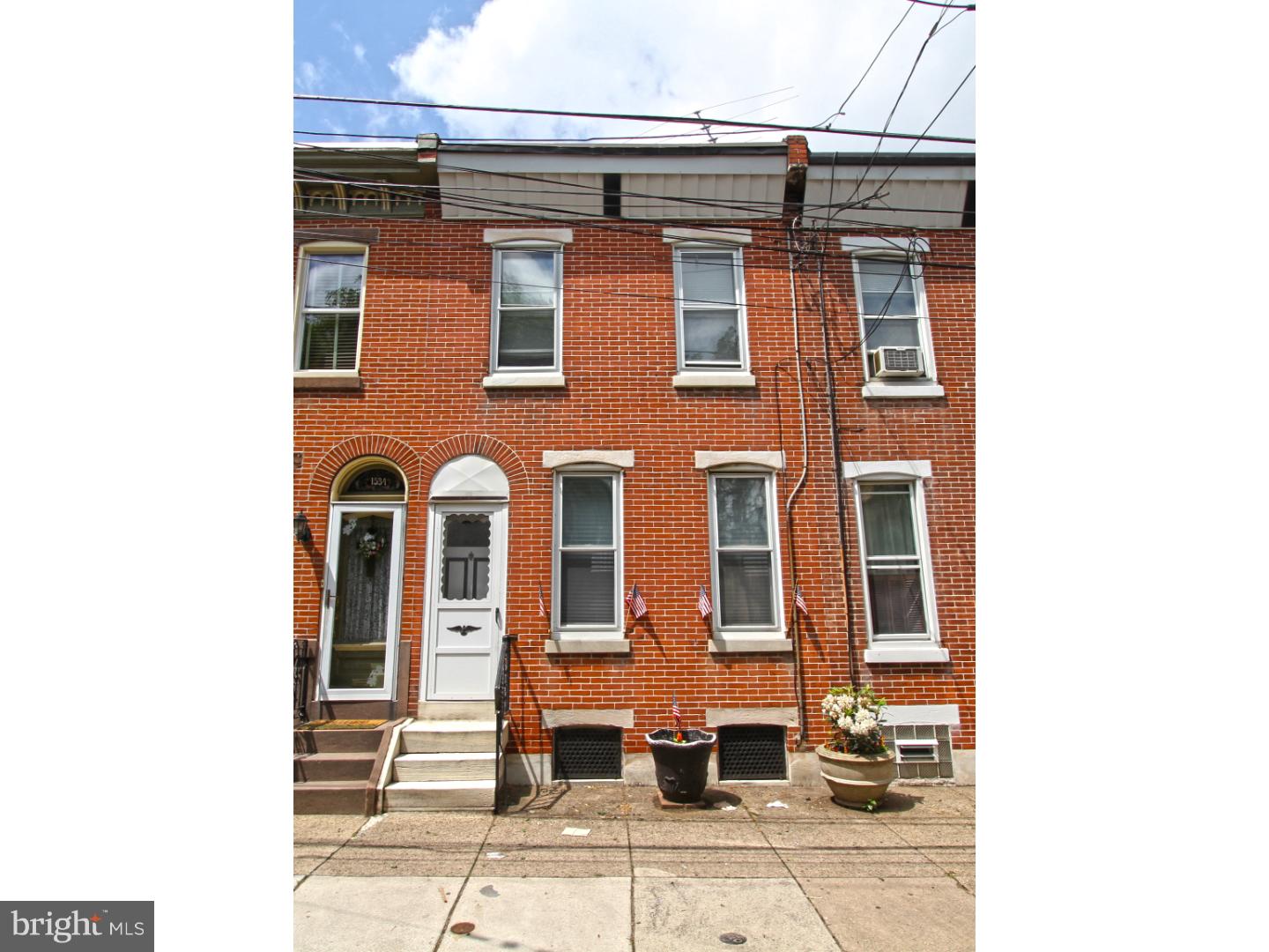 Can't beat the Location of this demure but charming 2 bedroom home in Fishtown. A handy homeowners delight! This 2 bedroom, 2 story, brick front, 1 bath with cemented rear yard offers an open airy lay out and is filled with natural light throughout. Enter in through a formal vestibule to an open living area with an L-shaped (feng shui friendly) staircase. There are original hardwood floors in the living room and in the vestibule. Walk through the living room to the open kitchen. The kitchen features cottage style cabinetry, recessed lighting and a peninsula with sink. The kitchen opens up to a multipurpose room that has a stack washer and dryer and offers space to create everything from a breakfast nook, gourmet panty, or anything your heart desires. Access to the rear yard through the kitchen and views of the yard through multiple windows. The 2nd floor has a huge hall bathroom ready to be turned into an amazing dream bath! The 2 bedrooms are spacious and sun filled and the master has exposed original hard woods along with the entire hall way. Radiator and base board radiator heat, gas cooking, full unfinished basement. Exciting opportunity here! We welcome your visit.