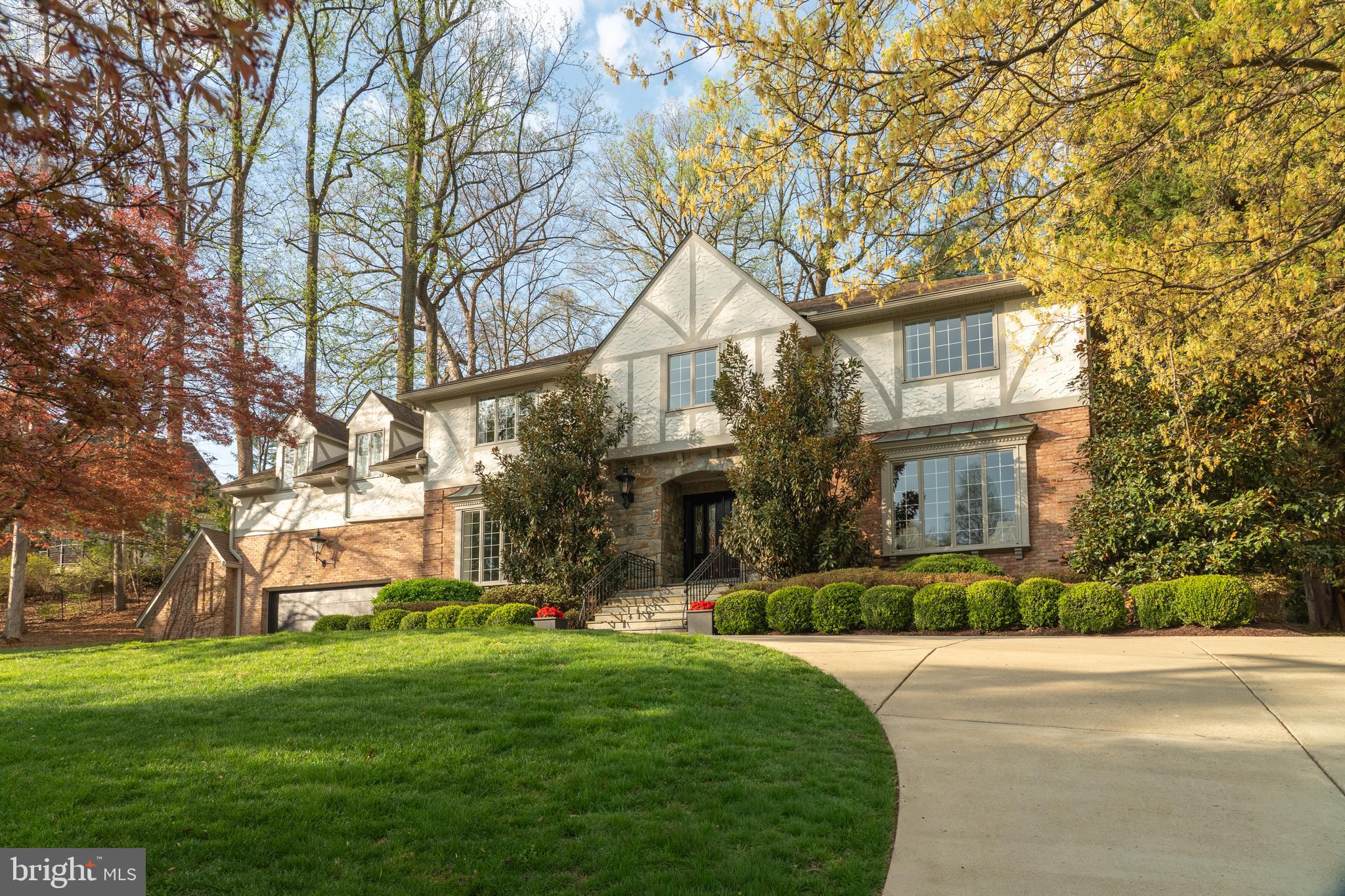 Welcome to 7204 Loch Lomond Drive, a gorgeous and expansive Tudor-style home with show-stopping curb appeal in coveted Bannockburn Estates. This 7800 finished sq ft  square-foot home with seven bedrooms and five-and-half bathrooms is perched on a lush green hill behind two scarlet Japanese maples and flanked by magnolia trees. Its outer beauty is just the prelude to a thoughtfully designed interior. With three fully finished levels, this truly turn-key home offers the perfect blend of individual and communal space, all updated with modern sophistication. <br>

A dramatic two-story foyer with a sweeping curved staircase sets an elegant tone upon entry. Six-foot-tall bay windows flood the adjoining living room with morning light and offer beautiful views of the neighborhood from on high. Across the foyer, matching bay windows grace the formal dining room, just steps from the gourmet chef’s kitchen, fully updated with marble counters, high-end appliances and custom cabinetry. An open floor plan links the kitchen with another dining area and a cozy entertainment space, anchored by a stately stone fireplace. A pair of French doors lead to the recently renovated backyard, featuring a custom Ipe hardwood deck and pergola, a sport court, a Japanese garden and an outdoor grilling area with a dedicated gas line. The first floor also features a large office with built-in bookcases and French doors to the backyard, as well as a laundry room with brand new washer and dryer and custom built-ins.<br> 
While the first floor is tailor-made for gathering and entertaining, the second floor offers everyone in the family their own private oasis: five generous bedrooms, all with beautiful views, ample closet space and newly renovated bathrooms. A long hallway leads to the pièce de résistance, a primary suite that blends comfort and luxury. It features high ceilings, a spa-like bathroom with steam shower and walk-in closet, a fireplace and a private second-story deck looking out on the backyard. <br>

The fully finished basement offers yet another opportunity for gathering, with a built-in high-top bar, a brick fireplace, a refrigerated wine room and more than enough space for a home gym and a comfy entertainment nook. It also includes a full bedroom with a brand-new bathroom that could act as an au pair suite or an extra guest room. The storage area is wired for a Sonos sound system, linking built-in speakers in the upstairs living room, kitchen, dining room and master bedroom, enabling music to play throughout the house.<br>

Recent updates enhance every aspect of the home’s functionality and comfort. These include two new high-capacity heating and air conditioning units, a water softener and drinking water filtration system, new gutters, full interior and exterior painting, a new garage door, new window coverings in the bedrooms, kitchen, and bathrooms, and elegant new chandeliers in the foyer and dining room, both of which convey with the home. Situated in one of the best public school districts in Maryland, the house also offers unparalleled convenience: the bus for Bannockburn Elementary picks up just across the street and the ones for Pyle Middle School and Walt Whitman High School pick up just down the street.<br>
