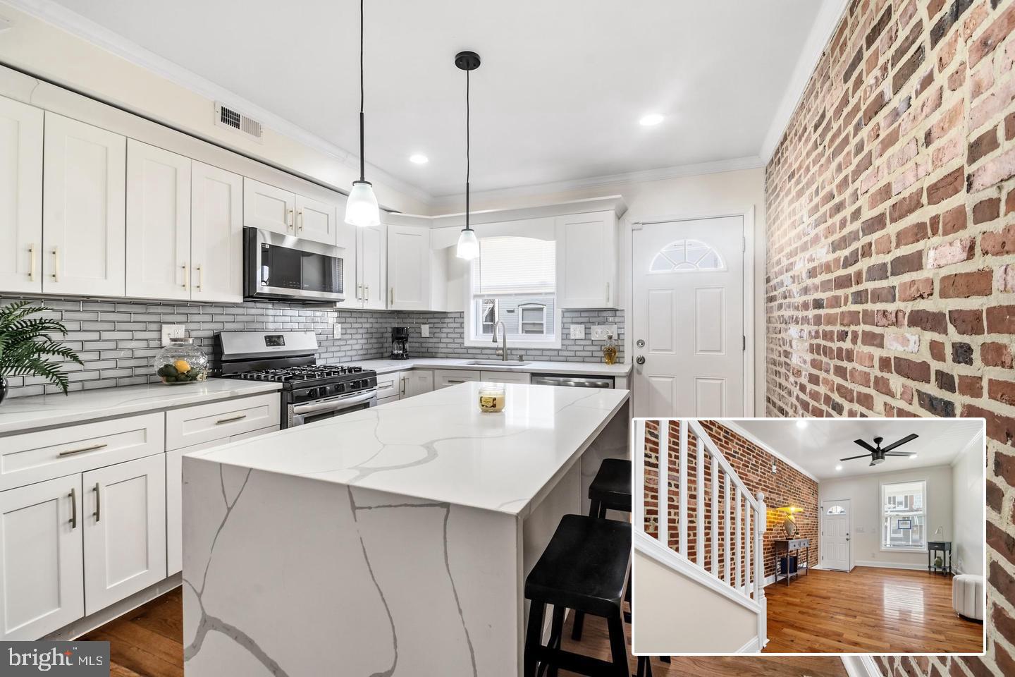 Well‑appointed and fully renovated, this home welcomes you with a large covered front porch and an impressive array of upgraded finishes. The main level features a light‑filled living room and a casual dining area that flows seamlessly into the stunning kitchen, complete with sleek stainless‑steel appliances, gas stove, built‑in microwave, a spacious island topped with premium quartz, and a decorative backsplash. From here, step out to the fenced rear patio — perfect for outdoor gatherings.

Upstairs, two generous bedrooms each offer hardwood floors and private en‑suite baths. The top level opens to a two‑tier rooftop deck with sweeping city views, an ideal setting for barbecues and get‑togethers. The finished lower level adds even more versatility with a family room, third bedroom, full bath, and laundry area.

Additional highlights include the covered front porch, fenced rear patio, and the coveted rooftop retreat. Conveniently located within walking distance to Ellwood Park and close proximity to Johns Hopkins.