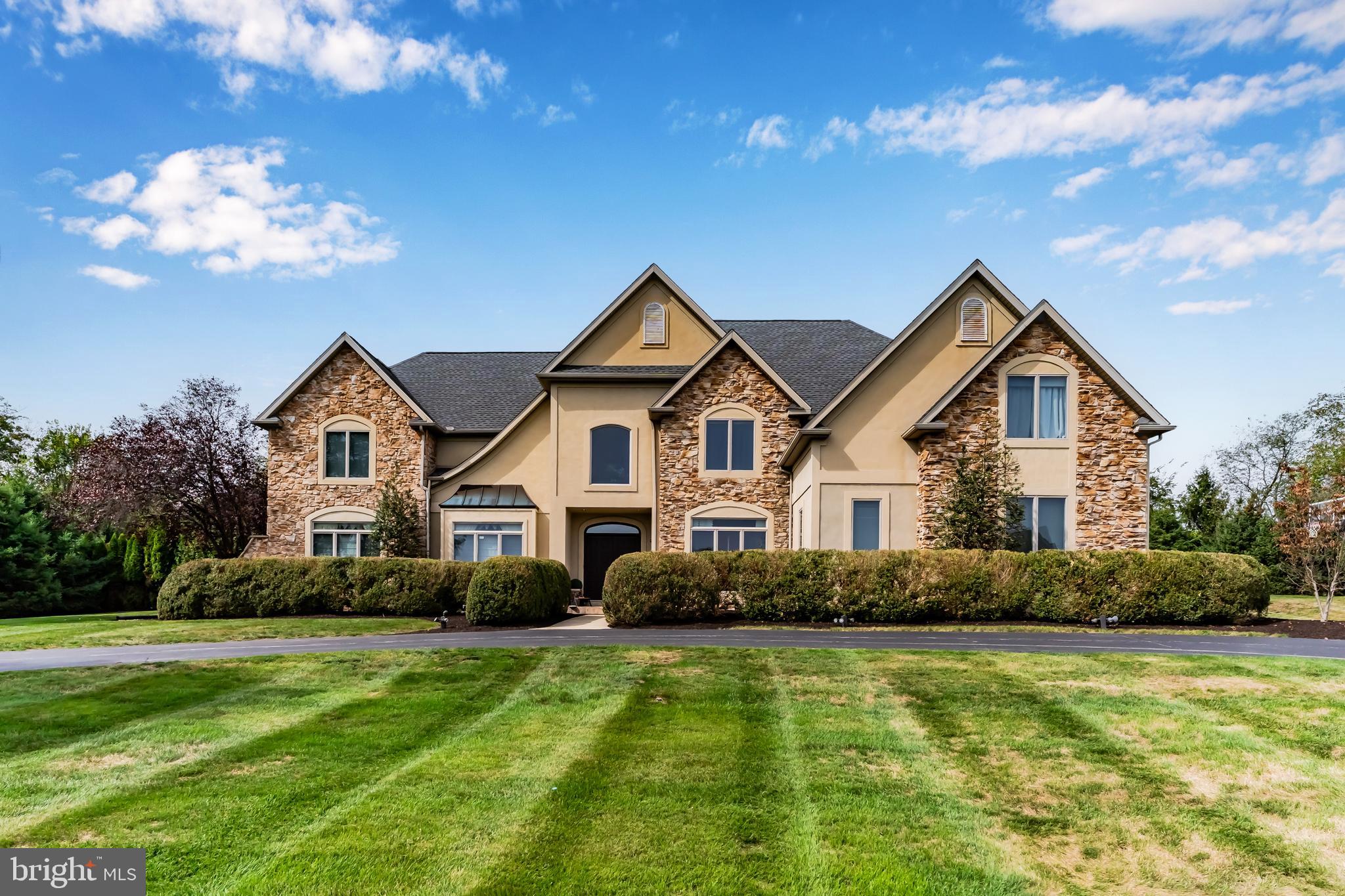 Welcome to 4216 Prosperous Drive — a stunning custom-built residence offering over 7,000 square feet of exquisitely finished living space in Central Dauphin School District. This impressive 6-bedroom, 5 full and 2 half-bath home blends luxury, functionality, and exceptional design for modern living.  The first floor showcases a chef’s dream kitchen with premium stainless steel appliances, four dishwasher drawers, dual Monogram refrigerator/freezer, a six-burner gas range with vent hood, and an expansive breakfast bar. The kitchen seamlessly opens into a grand dining area with vaulted ceilings and a built-in bar, creating the perfect atmosphere for entertaining. Relax in the inviting living room complete with a gas fireplace and soaring ceiling, or retreat to the formal living room for more intimate gatherings. A private office, home gym with half bath, mudroom with built-ins, and an additional half bath complete the main level.  Upstairs, the primary suite offers a spacious sitting area with gas fireplace, dual walk-in closets, and a luxurious en suite bath with double vanities. The 2nd bedroom includes its own private bath, while bedrooms 3 and 4 share a Jack and Jill design. A convenient laundry room is also on this level. A separate upper wing provides two additional bedrooms joined by another Jack and Jill bath—ideal for guests or extended stays.  The lower level is an entertainer’s paradise, featuring a spacious den with kitchenette, full bathroom, and even an indoor basketball court. Ample unfinished space provides storage options and bilco walk-out access.  The exterior boasts a large patio with pergola and hot tub, perfect for relaxing evenings outdoors. The semi-circular driveway offers easy access, and the oversized three-car garage includes built-in cabinetry for organized storage. Major updates include a new roof in 2024.  With unmatched space, thoughtful amenities, and premier location, this exceptional property delivers both comfort and sophistication — the perfect home for entertaining and everyday living, schedule your private tour today!