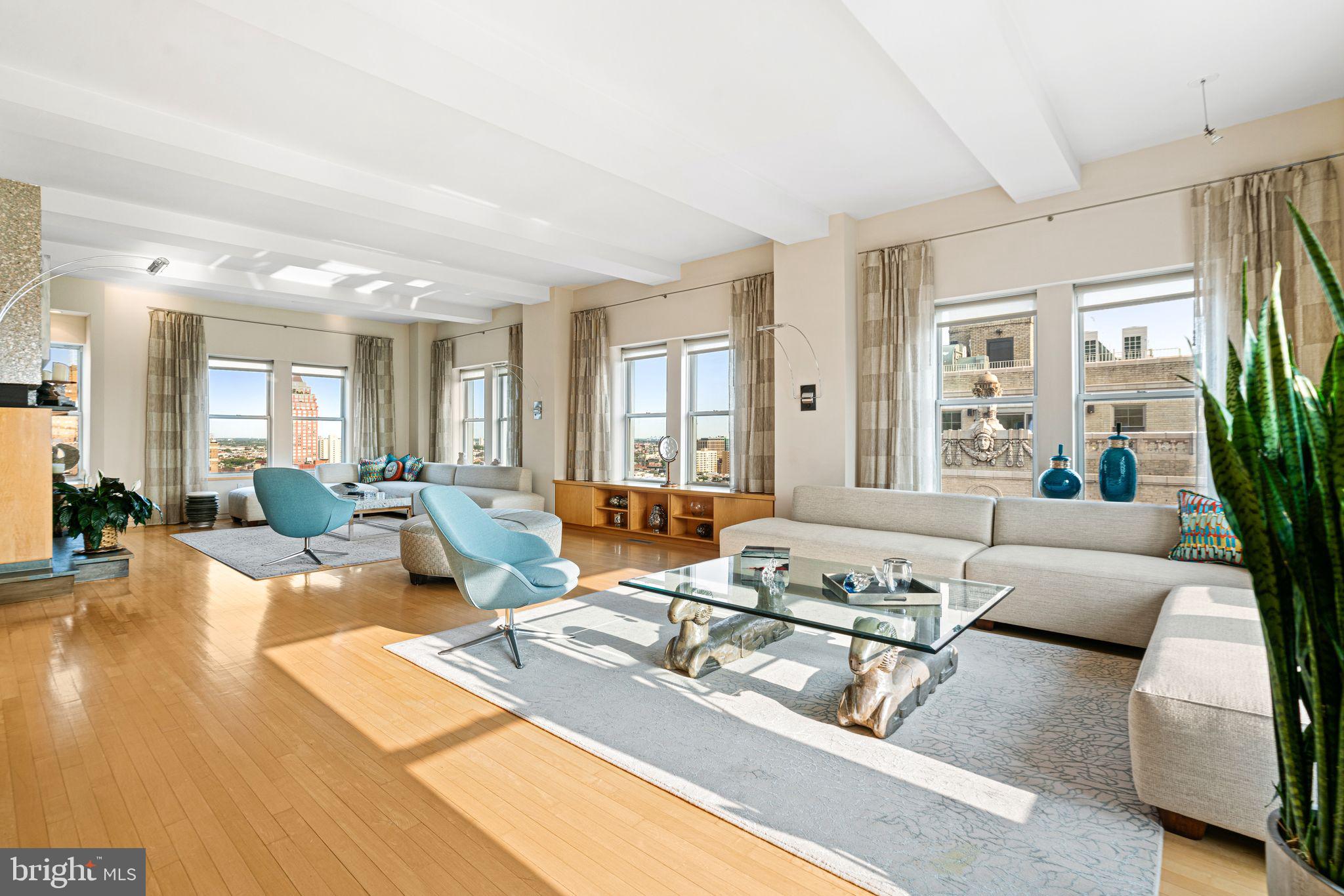 A RARE opportunity to own a WORLD-CLASS TWO-STORY PENTHOUSE with a spectacular PRIVATE ROOF DECK. Rittenhouse Place-with two full floors and private elevator entrance has been seamlessly combined into an expansive 4,400+ square foot home, offering unmatched privacy, luxury, and sweeping views of the Philadelphia skyline.
Step off the elevator into one of your two private secure vestibules with direct access into your penthouse. The upper level impresses with panoramic East, South, and West facing city views from walls of glass that flood the open-concept living space with natural light. Rich hardwood floors, two custom gas fireplaces made of slate and steel and an adjacent wet bar make this floor ideal for entertaining.
The recently renovated chef's kitchen - designed by renowned firm J Thom - is a showstopper. It features sleek Mobalco cabinetry handcrafted in Spain,  a quartzite island with a Wolf 5-burner gas cooktop and multi-speed range hood, sub-zero refrigerator and bar fridge, Wolf wall oven, and programmable steam oven, Just off the kitchen is a cozy family room with fireplace providing views of Rittenhouse Square.  A large dining area, powder room and an impressive temperature controlled wine room with a 2,000 bottle capacity completes the level.
Ascend the custom wood and cast-iron staircase to your private rooftop terrace—an extraordinary space large enough for grand-scale entertaining, yet intimate enough for sunset dinners. Enjoy lounge seating, grilling space, and jaw-dropping 360-degree skyline views.
The lower level is devoted to rest and retreat. The luxurious primary suite offers southern and western exposures, a spacious walk-in closet, and a spa-style bathroom with double vanities, a soaking tub with skyline views, a glass-enclosed shower, and a private sauna. Three additional bedrooms provide flexibility for guests, home offices, or a gym, and share a beautifully appointed full bath. Seller will pay for 1 year of parking at a local garage.
Just steps from Rittenhouse Square, this penthouse offers immediate access to Philadelphia’s best dining, shopping, cultural institutions and universities.