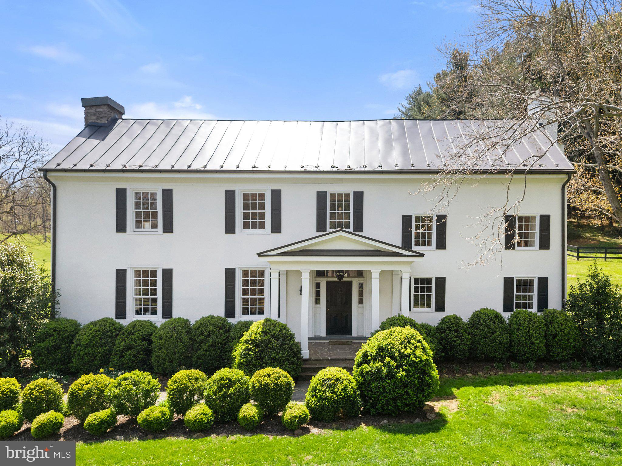 Welcome to Slate Hill, an exquisite country estate on almost 10 acres. Fully renovated interior and exterior in 2021 with all original features retained, including wide heart pine flooring throughout and detailed woodwork. This elegant c. 1700’s property has 4 bedrooms, 2.5 full baths and combines a wonderful mix of old and new. The property was originally a portion of the 2,000 acre land patent granted to George Washington by Lord Fairfax in 1768. The original house and cabin structures date from 1770s with additions to the house built in the 1820s.

A stone entrance bridge with stone pillars crosses a small spring-fed stream, flanked by ancient boxwoods and wrought iron gates. A large parking area and driveway provides ease of access. Towering trees ring the property, providing a sense of your this beautifully private glen.

The perfect country lifestyle awaits inside the house. A gourmet kitchen offers soapstone counters, custom cabinetry, farmhouse sink, imported AGA appliances and a casual dining area. The formal dining room retains its exposed original stone walls, restored beams, original fireplace and antique lighting. Living Room has expansive windows allowing the natural light to flood in, 9ft ceiling beams, and the original fireplace mantle. The master bedroom has a fireplace, cedar closets and a luxury bath with custom slate shower walls and Hansgrohe Raindance showerhead and fittings. Of the three guest bedrooms, one includes an en-suite bathroom and two walk-in wardrobes.

Other features include new standing seam metal roofs on the main house and cabin, a new two-zone HVAC system, and a new washing machine and dryer (2024). A large stone patio is reached through the kithcen. Extensive mature landscaping and gardens surround the house.

George Washington's original log cabin has been fully restored with a repointed chimney & two fireplaces, a loft bedroom and new full bath.

Horse amenities include a center aisle barn by renowned builders King Construction (2021), with four oversized stalls, tack room, bathroom, wash stall and feed/laundry room. A breezeway with carriage doors provides beautiful airflow and views. Behind the barn, are four fenced paddocks and a 120x70 EquiSand riding arena that suits all riding disciplines.