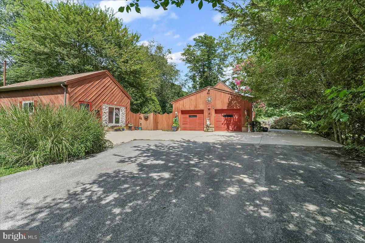 A rare opportunity in a prime location - perfect for professionals and nature lovers alike. Nestled just off Route 1 and a stone's throw from iconic Longwood Gardens, this unique 1.5 acre property features two dwellings on one parcel a beautifully crafted Cape Cod style Maine Post and Beam home and a separate 700 ft² private office just steps from your door, whether you're a consultant, therapist ,designer ,  or remote worker ,this setup is a dream come true. 
Enjoy the benefits of a highly visible signage on Route 1, while maintaining complete privacy. A 600 ft  private drive leads to your tranquil sanctuary tucked away and meticulously maintained through an existing shared agreement with the neighboring property.
The grounds are nothing short of magical, complete with heart-shaped pond with waterfall , lighted gazebo, and expansive open space, ideal for relaxation, reflection or small gatherings. 
This three-bedroom 2.5-bathroom home offers warm and inviting living spaces across three levels. 
First floor: Cozy living room with gleaming hardwood floors, a bank of new windows with a window seat, a Valley Forge white stone fireplace, formal dining room, full eat in kitchen with hardwood floors a garden window and custom copper backsplash and a flexible first floor bedroom currently used as an office, as well as a full bath with a stall shower, as well as a formal dining room.
Second floor: private main suite with jacuzzi whirlpool tub and  handheld shower,  loft overlook, currently being used as a dressing room, but also perfect for reading nook, creative space or office extension. 
Lower level: expansive third bedroom with half bath, large family room with wet bar, and additional flexible space for guests to enjoy.  Natural light pours in through seven skylights, all outfitted with custom shades. The homes character is further enhanced by quality craftsmanship, post and beam details,
(see more details on UPGRADES AND SPECIAL FEATURES in Bright additional paperwork) and a sense of welcoming comfort throughout.
There is an attached oversized two-car garage with workbench, ideal for the hobbyist or handyman. Enjoy Your morning cup of coffee and you're lazy summer evening views from your scenic brick patio, as well as the spectacular Longwood fireworks view, five times a year, on your sprawling deck which is  also the  perfect spot for entertaining and hosting large gatherings.

The second dwelling is a private office with a half bath, a waiting room, a administrative assistant's room, and two separate offices. Parking is plentiful. 

This one-of-a-kind property blends professional convenience with personal serenity, all in an unbeatable location. You truly must see it to appreciate the lifestyle it offers.

Schedule your private tour today. Check out the video icon above for your virtual tour! The new price makes accommodations for prospective buyers to perform updates that they would like to make to the property. (Photos of interior have been digitally de-cluttered to show the property's true potential)