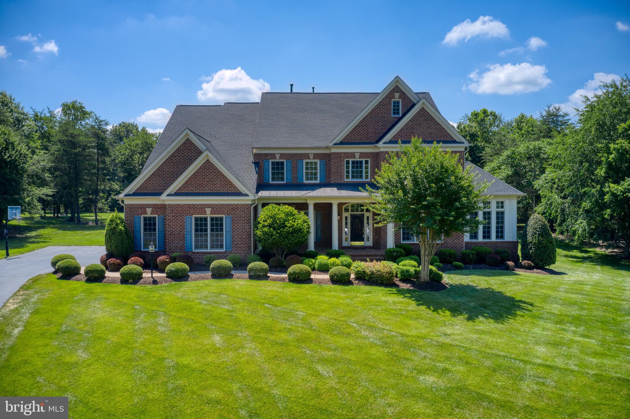 This gorgeous estate home has everything you want and more. Located in Chantilly, on a flat usable 3+ acre lot, this perfectly designed Lancaster II model has 5 bedrooms, 6.5 bathrooms, a 3-car garage, and over 7400sf of living space. The sought-after Cedar Crest community is unlike other areas with public water & sewer, natural gas, extra wide streets, and walking/running paths. Close proximity to coveted St. Paul VI Catholic high school and Loudoun County schools. Less than 20 min to the heart of Chantilly, 25 min to Dulles (IAD), and 40 min to Tysons. The main level consists of a 2-story foyer with a curved staircase, living room, sunroom, office, dining room, family room with a fireplace, half bath, morning room, mudroom, full bathroom, and laundry room. The gourmet kitchen has upgraded cabinets, a large island, granite counters, SS appliances, a walk-in pantry, a butler's pantry, and desk space. The upper level has a prominent owner's suite with a sitting room and covered veranda overlooking the expansive backyard. The owner's bathroom has dual vanities, a dual entry shower, a soaking tub, two water closets, and a spacious walk-in closet. There are four secondary bedrooms, two with private baths and two with a shared bath. The lower level is ready for entertaining fun with a large rec room, theater room, full bathroom, storage, and rough-ins for a wet bar & 6th bedroom or bonus room. The backyard is your own private oasis complete with a stone patio overlooking a serene, very usable flat lot with mature trees away from the hustle and bustle.