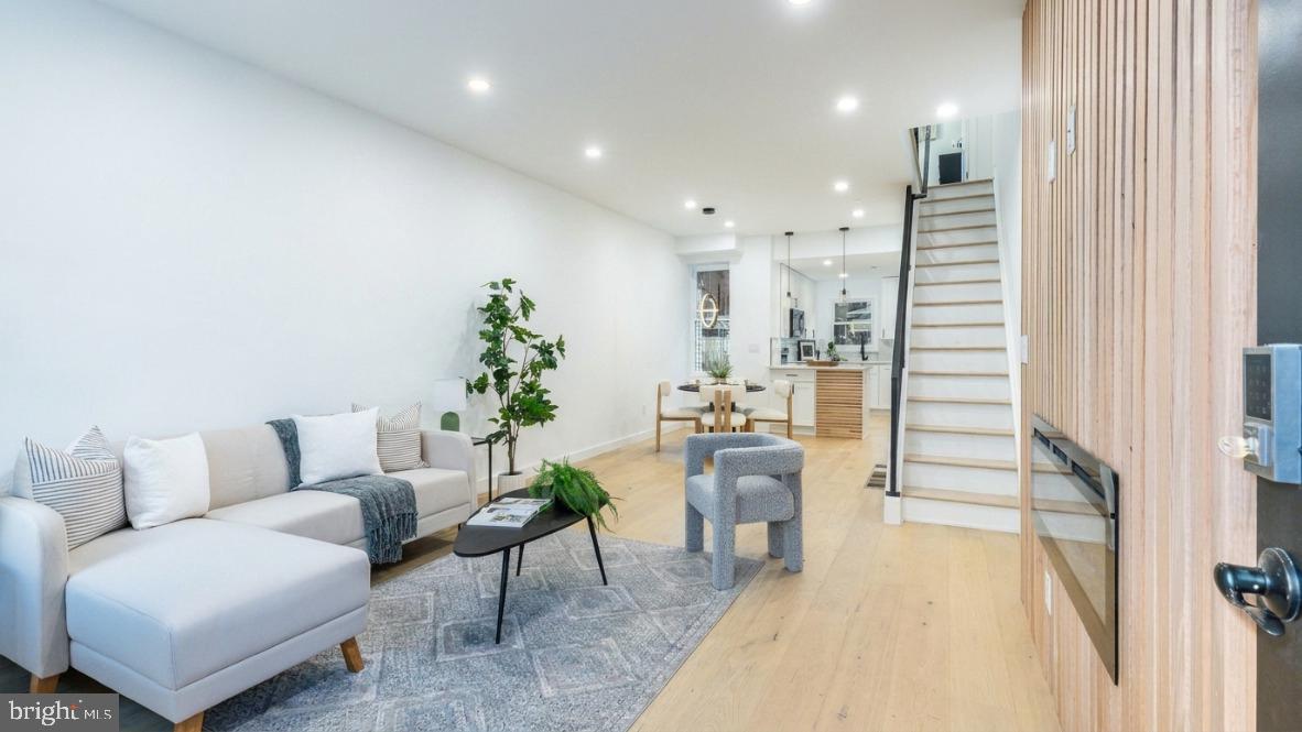 Welcome to your dream home—where modern design meets urban convenience! This stunning 2-bed, 2-bath gem isn’t just a house… it’s a whole vibe. Step inside, you’re greeted by an electric fire place with modern wood paneling, sleek recessed lighting, and white oak flooring. The open-concept living space flows into a jaw-dropping kitchen with quartz countertops, a waterfall-edge, and white shaker cabinetry with black hardware. The fully finished basement offers extra living space, laundry, storage, and gorgeous custom full bath with shower. Upstairs you will find 2 bedrooms with the primary featuring a custom black accent wall with sconce lighting and restored wood desk to work from home in style! The full bathroom on this floor will impress with trendy finishes. Plus, this home qualifies for the Bank of America grant—making luxury more affordable. Location? Absolutely unbeatable. Just minutes from Frankford Ave’s buzzing restaurants, Aramingo Ave’s shopping (ShopRite, Ross, and more), and easy I-95 access. Walk to parks, gyms, and public transit, or explore Port Richmond’s eclectic dining scene. With a fireplace for cozy nights and chic custom details at every turn, this move-in-ready haven is waiting for you. Your vibe is here—claim it!