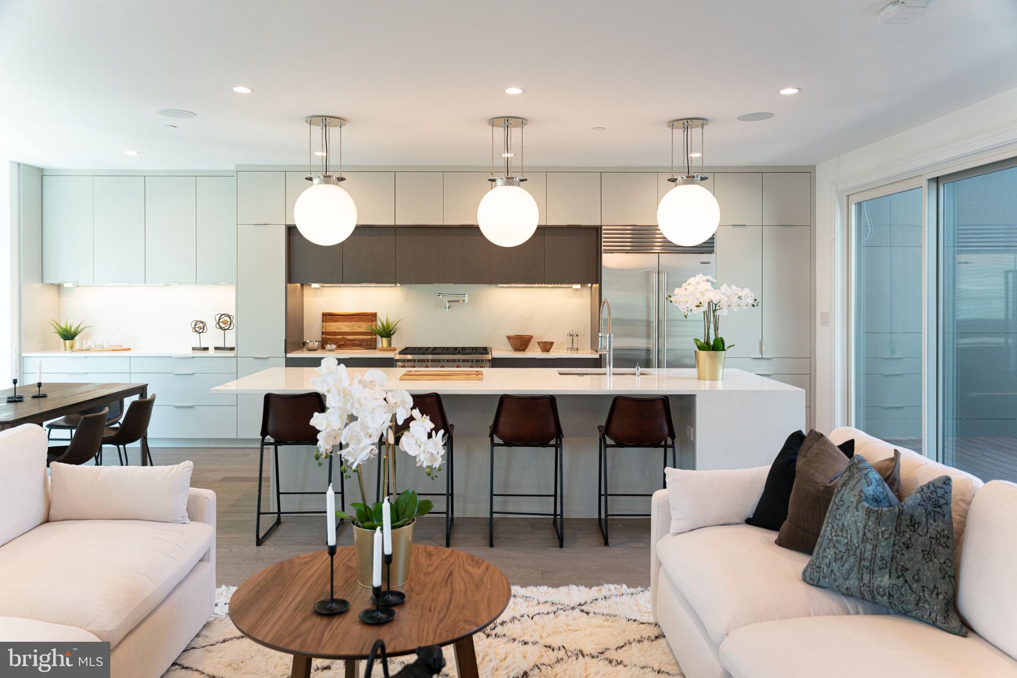 The luxurious elements in this EXTRA-WIDE townhome are apparent in every detail from its rarely offered 35 foot width to the high-end Waterworks fixtures. It also features a 2 car garage, an elevator, considerable architectural design, gorgeous baths featuring Porcelanosa tile and Waterworks fixtures, thoughtful finish upgrades, and multiple outdoor spaces. The flow of the open floor plan is enhanced by an elegant fireplace and the extra wide plank wood floors that lead into a gourmet Chef's kitchen which features a six burner Wolf stove with pot filler and Sub-Zero appliances as well as handcrafted cabinetry throughout and an island like no other! The Owner's Suite features large walk-in closets, oversized windows for ample natural light, and a spacious bathroom with a large standing shower and gorgeous stand alone soaking tub. The home features 4 bedrooms, 4 full baths, and 2 half baths as standard. Conveniently located near gyms, restaurants, shops and more.