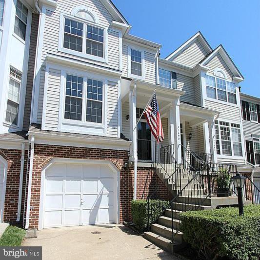 This townhouse is a 10+,  it is stylish, loaded with natural light, and beautifully updated.   You'll appreciate the hardwood floors and the contemporary finishes. Starting with  the open-concept kitchen designed for both everyday living and entertaining, featuring espresso cabinetry with glass panel fronts, stainless steel appliances,  designer honeycomb backsplash, and modern pendant lighting.

The spacious living area is framed by dramatic floor-to-ceiling windows overlooking mature trees, creating a peaceful retreat rarely found at this price point. Step outside to the private deck and enjoy morning coffee, outdoor dining, or relaxing with friends while surrounded by nature.

Upstairs, you'll find two spacious bedrooms with vaulted ceilings and beautifully remodeled bathrooms that deliver a fresh, modern feel. The versatile walk-out lower level offers endless possibilities as a third bedroom, family room, home office, gym, or guest space. Complete with a cozy electric fireplace, half bath, and direct access to a fenced backyard featuring a lower deck and attractive stone retaining walls.

With approximately 1,400 square feet of thoughtfully designed living space and a one-car garage, this home truly lives larger than expected.  more driveway parking and extra  guest parking in 2 nearby areas. 

Recent updates include:
• New roof (2026)
• Updated windows
• Fresh paint throughout 2026
• New carpet 2026
• Remodeled bathrooms
• Updated kitchen
• Stainless steel appliances
• Designer lighting and custom finishes
New lower level decking 2026

Enjoy the privacy of townhouse-style living with no neighbors above or below. 

The amenity-rich community offers:
• 5 swimming pools
• Tennis / pickleball courts
• Fitness center
• Community center
• Tot lots and playgrounds
• Walking trails and picnic areas
• Optional golf membership

Outdoor enthusiasts will love being just steps from Seneca Regional Park, Algonkian Regional Park, and the scenic Potomac River, offering miles of trails, kayaking, golf, and waterfront recreation.

Commuters will appreciate the unbeatable location with quick access to Route 7, Route 28, and the Dulles Toll Road, while Washington Dulles International Airport is less than 15 minutes away.

Move-in ready, beautifully updated, and packed with lifestyle amenities—this is the one you've been waiting for.