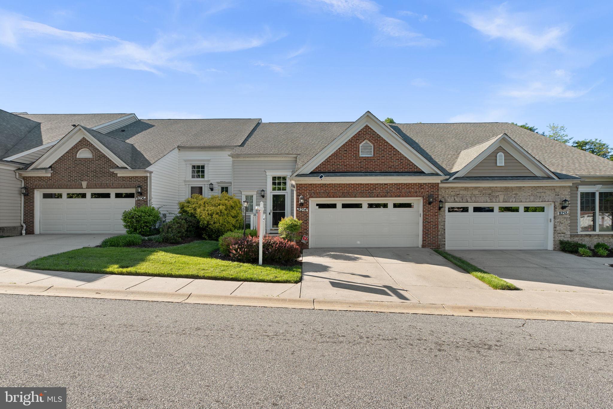 Welcome to this beautiful 4-bedroom townhome located in the highly desirable 55+ community of Village Crest, offering elegant finishes, spacious living areas, and exceptional community amenities. Thoughtful architectural details including crown molding and paneled lower walls add timeless charm throughout the home, while gorgeous hardwood floors flow across the main level.


The pretty kitchen features granite countertops, pantry storage, and breakfast bar seating, opening to a warm and inviting family room with a cozy gas fireplace. Just beyond, the bright breakfast room/sunroom provides direct access to an enclosed porch complete with its own electric fireplace—perfect for relaxing year-round.


The convenient main-level owner's suite offers comfort and privacy with an ensuite bathroom featuring a double sink vanity, a walk-in tub, and separate shower. A half bath and laundry room on the main level add to the ease of everyday living.


Upstairs, a spacious loft overlooks the foyer and is accompanied by two generously sized bedrooms and a full bathroom—ideal for guests or additional living space.


The finished lower level offers incredible flexibility with a large recreation area perfect for a home gym, media room, or hobby space, along with a fourth bedroom and full bathroom. A door from the lower level leads to a beautiful partially covered patio for additional outdoor enjoyment.


Additional highlights include a 2-car garage and a premium location backing to open space with plentiful overflow and guest parking nearby. Residents of Village Crest enjoy outstanding amenities including indoor and outdoor pools, tennis and pickleball courts, fitness center, and an activity-filled clubhouse, creating a vibrant and active lifestyle community.