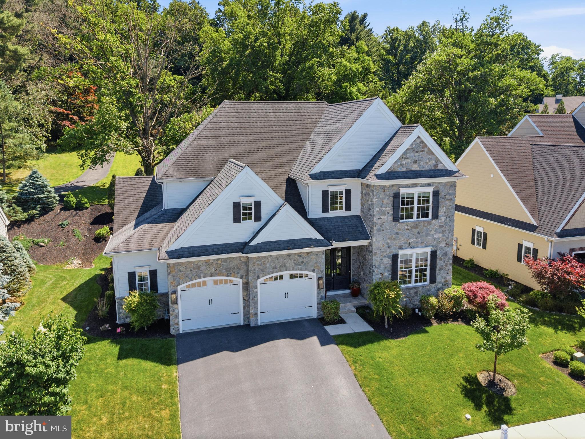 Welcome to 360 Addison Place—an exceptional 5-bedroom, 4 full and 1 half bath luxury home offering over 4,300 square feet of finished living space in the lovely Spring Haven community of Manheim Township. Built in 2017 and backing to mature trees, this beautifully appointed residence combines elegant design, spacious living areas, and upscale finishes throughout, creating a home that is equally suited for everyday comfort and sophisticated entertaining.

Inside, a grand and thoughtfully designed layout showcases soaring ceilings, exposed beams, custom millwork, and refined architectural details throughout. The welcoming foyer opens to a private office and elegant formal living and dining spaces, creating an impressive first impression while maintaining a warm and inviting atmosphere. Rich finishes, abundant natural light, and an open-concept design allow each space to flow effortlessly into the next.

At the heart of the home is a stunning gourmet kitchen designed for both entertaining and everyday living. Featuring granite countertops, a large center island with seating, abundant cabinetry, pantry storage, high-end appliances including double wall ovens and a gas cooktop, and thoughtfully designed built-ins, the kitchen offers exceptional beauty and functionality. The adjoining family room is anchored by a striking double-sided gas fireplace, creating a warm focal point shared between the living spaces and enhancing the home's open flow. A well-appointed mudroom with custom built-ins and a stylish powder room complete the main level.

Upstairs, the luxurious primary suite serves as a true retreat, featuring a spacious dressing area, expansive walk-in closet, and a beautifully appointed en-suite bath complete with a soaking tub, walk-in shower, and elegant custom finishes. Three additional bedrooms provide generous accommodations, each with walk-in closets and direct bathroom access. Two bedrooms share a well-designed Jack-and-Jill bath, while another enjoys its own private bath. An upper-level laundry room adds everyday convenience and functionality.

The finished lower level significantly expands the home's versatility and entertaining potential. Featuring a spacious recreation and living area, a wet bar with granite countertops and built-ins, an additional bedroom, and a full bath, this level provides an ideal space for hosting guests, recreation, fitness, or flexible living arrangements.

Outdoor living is equally inviting, with a screened rear patio area, complete with ceiling fan, overlooking the private backyard and wooded backdrop. The rear setting provides a peaceful retreat while still being conveniently located near schools, shopping, dining, parks, and major commuter routes. Beautiful mature landscaping and attractive curb appeal further enhance the home's outdoor spaces.

Additional highlights include an oversized attached 2-car garage with built-in storage, central vacuum system, security system, and exceptional attention to detail throughout. Combining luxury finishes, generous living spaces, and a premier Manheim Township location, this remarkable Spring Haven home offers the perfect blend of elegance, comfort, and convenience. Schedule your private showing today!