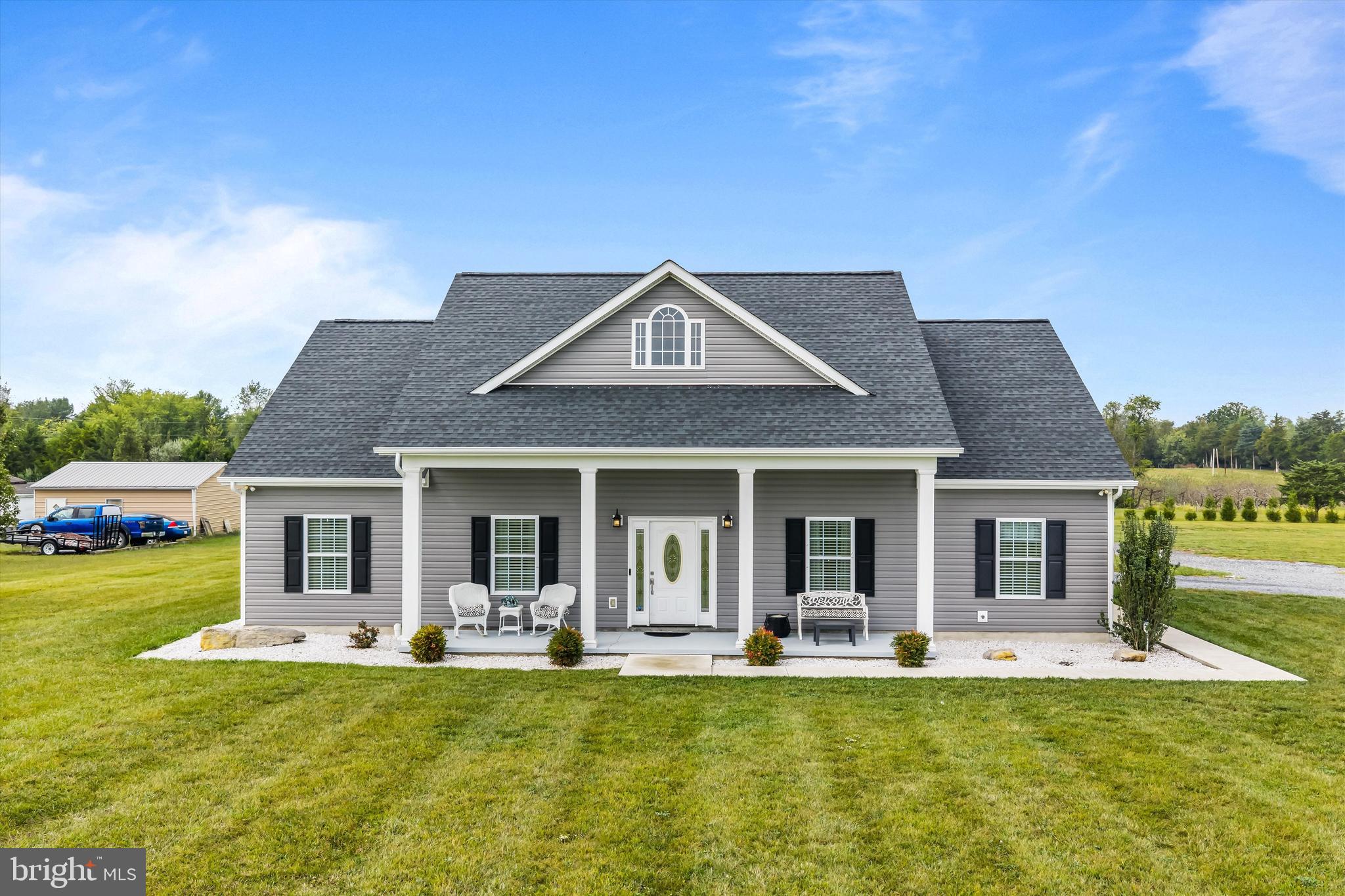 Stunning TO BE BUILT custom built home. Similar construction shown.  Features 3 bedrooms and 2 full baths all on one level and a 6.15 acre lot. This home has so much curb appeal, with the lovely symmetry of the building. The attached 2 car garage is side loading. You get the convenience of a garage without the eyesore. The large covered porch is ready for your rocking chairs. Inside you enter into the great room, with recessed lighting, ceiling fan, and stunning gas fireplace with built-in surrounds. The living room is open to the dining room and kitchen. This space is great for entertaining.  The island provides breakfast bar seating for 3. There is a large pantry for storage. Down the hall you have a large laundry room with sink and ample shelving storage. The primary suite features recessed lighting, ceiling fan and beautiful tray ceiling detail. The suite includes a private, ensuite bathroom. This luxury space features separate single bowl vanities, a walk-in shower, and a gorgeous free standing soaking tub. Your suite is topped off by a huge walk-in closet to exceed your storage needs. On the other side of the living space, you have 2 large bedrooms with overhead lighting and large closets. The hall bath features an extended single bowl vanity and tub/shower. Outside the rear of the home, you have another large covered porch. This is a great space to entertain in the warmer months! Call for more information today!