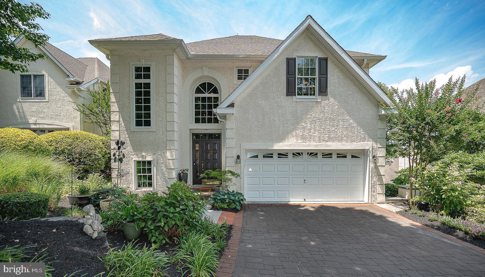 This spacious, open floor plan home sits on one of the best lots in Merion Hill, with no exterior steps, making it the "just right" home you've been waiting for.  With its two-car attached garage, you can walk right into this cheerful living space with ease.  The stunning two-story foyer leads to the home's main level living area, which seamlessly blends the Family Room with gas fireplace, the Dining Room Area and the heart of the home, the large, bright Kitchen with counter seating for four to five.  Meal prep is a pleasure in this home with plenty of counter space and storage, stainless steel appliances and a  desk area in the kitchen as well as easy access to the garage.  A gracious staircase to the second floor, where you'll find double doors to the primary suite retreat with a sitting area, modern  fireplace, tray ceiling, with ceiling fan, three closets (one is a walk in) and luxurious Primary Bathroom with dual sinks,  walk in tiled shower and a luxurious large soaking tub. Two other good sized bedrooms each with ceiling fan , hall bathroom and Laundry Room complete the second level.  The Lower level is truly bonus living space, with flexible use options.  The main "hang out" room features a gas fireplace and sliders to the private lower level patio,  as well as to the spacious 4th Bedroom, with attached Full Bathroom.  It is currently being used as a gym, but could be used as a Hobby Room or for extra storage.    Beautiful matchstick shades and Silhouette blinds throughout most of home.  This house is equipped with a whole house water infiltration system and central vac.   Merion Hill is centrally and perfectly located minutes major arteries (76 and 276), the Main Line, King of Prussia and downtown Philadelphia.  Don't miss this one!