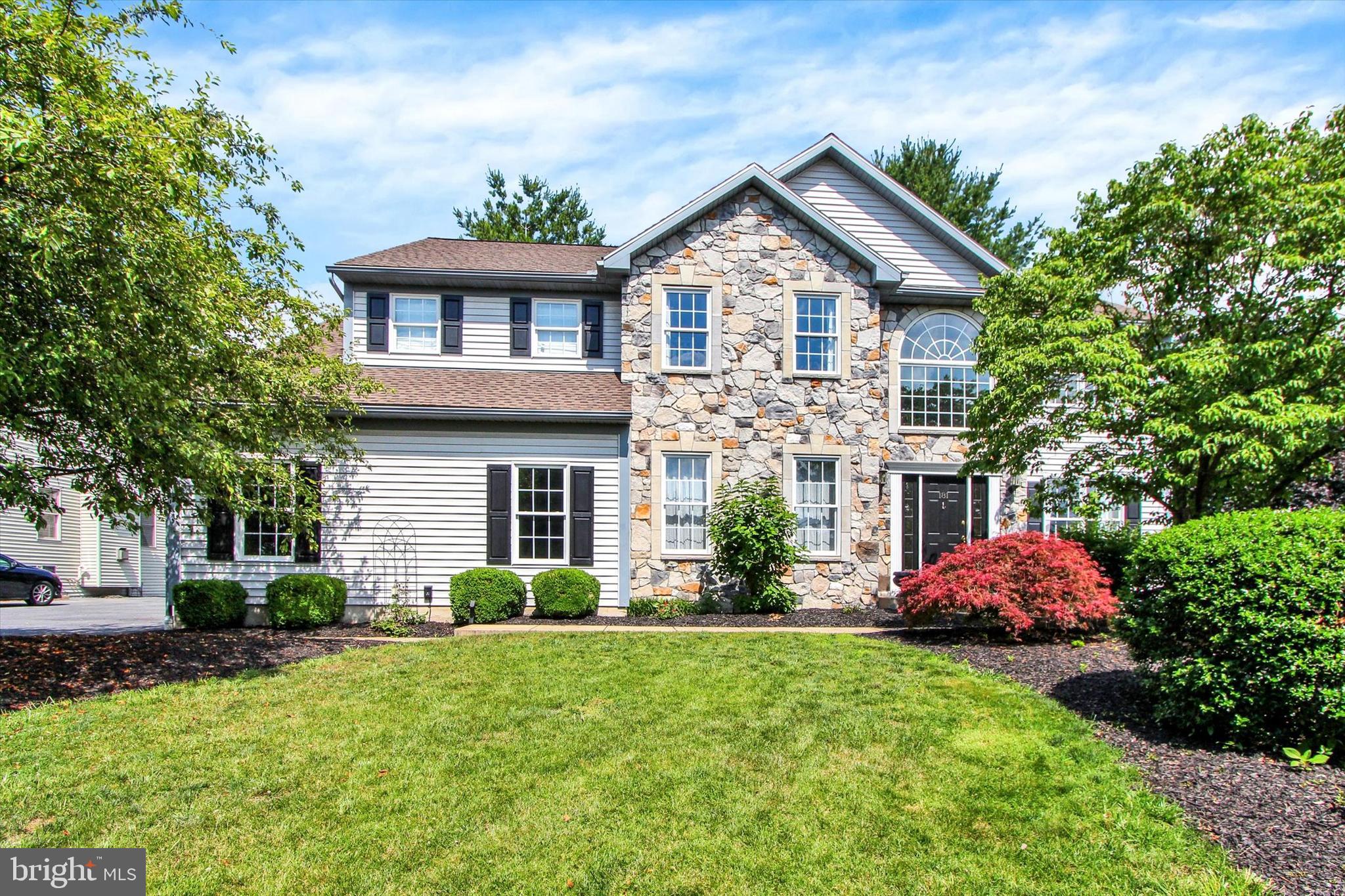 This beautiful ​4-bedroom​, 2.5 bath 2-story is located in ​the highly desired development of Green Valley on a private half-acre lot. Inside, elegant solid ​Brazilian Cherry flooring runs through the entryway, living room, and dining room. These formal spaces also show off numerous ​u​pgraded details like tray ceilings and custom wall moldings. The high-end kitchen features quartz counters, stainless steel appliances, a custom island​, and a gorgeous wall of windows that start over the sink and counter and expand into two impressive sliding glass doors. This open concept space flows nicely into the expansive family room which boasts a two-story ceiling with skylights, a cozy gas fireplace, and arched windows. A grand second-floor balcony looks down into this living space. This floor also includes a separate laundry room, and a large private office. 
Upstairs, the main bedroom suite serves as a relaxing retreat. It comes with a large walk-in closet, a separate sitting area, and a newly remodeled bathroom that features a tile walk-in shower, a standalone clawfoot bathtub, and a dual sink vanity.  The remaining 3 bedrooms are also very nicely sized and share a large hall bath, also with a double sink vanity. Downstairs there is a massive walk-out basement with full-sized windows that let in plenty of daylight. Outside, a relaxing private deck looks over the circular driveway and beautifully landscaped backyard. This home also features a brand new roof that was installed in 2025, and has access to nearby parks and common areas. So schedule your showing today!