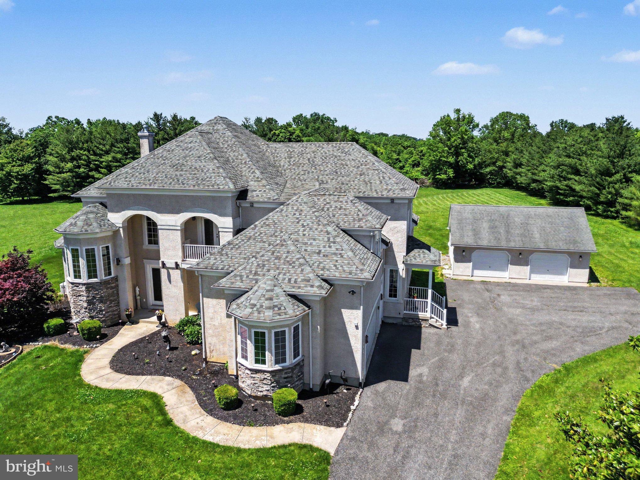 Absolutely stunning!!! Rurally located and BEAUTIFULLY maintained, 4-bedroom, 4.5 bath custom built, stucco colonial situated on 2 peaceful and private acres, featuring 4,280 finished sq. ft. of open and airy living space with close proximity to I-95, Rt. 40 and the Pennsylvania State Line. As you enter you will be greeted with a lofty 2-story ceiling, stunning oak flooring and 10' ceilings throughout. Main level highlights include a grand foyer, sitting room, home office, sizable great room, dining area, gourmet kitchen, laundry, bedroom with an attached bath as well as a half bath. Great room features include a stone floor to ceiling propane burning fireplace and French doors leading to a sweeping composite deck and backyard. Kitchen details include stainless-steel appliances, 2 dishwashers, a large island, sleek granite countertops, a walk-in pantry, peninsula with seating, glass tile backsplash and loads of beautiful cabinetry with plenty of storage. Adjacent to the kitchen is a sprawling dining area, also with deck access, ideal for entertaining and large family gatherings. The upper-level can be accessed by 2 separate staircases with highlights that include 3 spacious bedrooms, all with attached bathrooms and walk-in closets, as well as a bonus room with balcony access which could be utilized as an exercise room, play area or second home office. Primary bedroom details include access to a generously sized private balcony (perfect for morning coffee!), walk-in closet with separate laundry and a 13' X 18' attached bathroom. Features include a HUGE walk-in tiled shower, jetted soaking tub, private water closet and ceramic tile flooring. Idyllic views of nature from every room! The full poured concrete basement includes a finished 57' X 18' recreation room, 13' X 43' finished gaming area/hobby room, additional finished area and a utility room. Additional property details include 2 "Energy Star" tankless water heaters (main level and upper level), a Generac generator, an attached 2-car garage, a detached 2-car garage with upper-level storage, attractive landscaping and wiring for security. Recent upgrades include 2 new HVAC units, main level added 2024 and upper-level unit added in 2025. Truly shows pride of ownership throughout. If you are searching for an impeccably maintained, expansive and tucked away place to call home, your search is over... 627 Doctor Miller Road... A WONDERFUL place to call HOME!!!