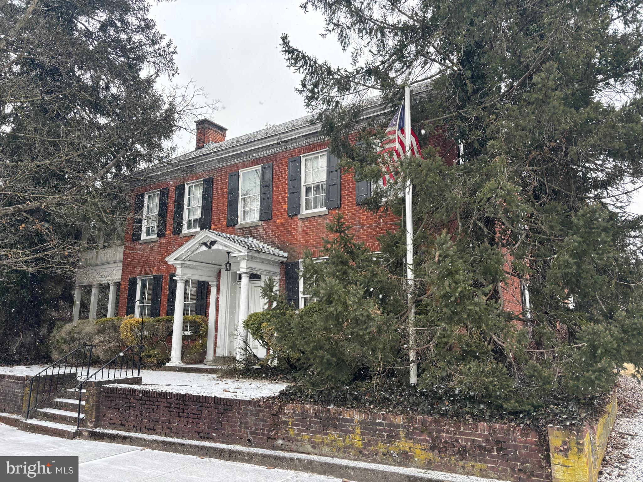This property will be offered at Public Auction on Thursday, April 17, 2025 @ 6pm.  The listing price is the opening bid only and in no way reflects the final sale price.  10% down due at auction, 2% transfer tax to be paid by the purchaser, real estate taxes prorated. This stately New Oxford home has been beautifully preserved to maintain its original charm. From the classic brick front entrance to the exquisite exterior dental molding, every detail reflects timeless elegance. The two-story covered porch and balcony, framed by ivy and mature hedges, offer a picturesque welcome. Inside, the formal entrance showcases original wooden double doors, leading to a stunning open staircase. The home boasts soaring ceilings, extra-large windows, and rich architectural details throughout. The formal living and sitting rooms, connected by an original set of sliding pocket doors, provide a perfect setting for entertaining, and the formal office features a marble fireplace, and built-in bookcases. The spacious eat-in kitchen highlights exposed wooden beams, cherry cabinetry, and an original walk-in fireplace, complemented by a butler’s pantry. The large formal dining room, complete with a fireplace, is perfect for hosting large gatherings. The second floor, accessed by a winding staircase, features hardwood floors, four spacious bedrooms, three full bathrooms, and an additional sitting room with an English bar that could serve as a fifth bedroom. Hallways lined with window box seats, large closets, and a back staircase leading to the kitchen add to the home’s character. A rumored hiding spot in the back bedroom is said to have ties to the Underground Railroad, adding a fascinating historical touch. Outside, brick walkways, a charming patio, and lush landscaping create a serene retreat. The detached two-car garage includes a workshop and garden shed for added convenience. This remarkable home has been lovingly maintained and is ready for its next chapter. While some cosmetic updates may be desired, its historic beauty and stately manner remain unmatched. Don’t miss this rare opportunity to own a piece of New Oxford’s history!
