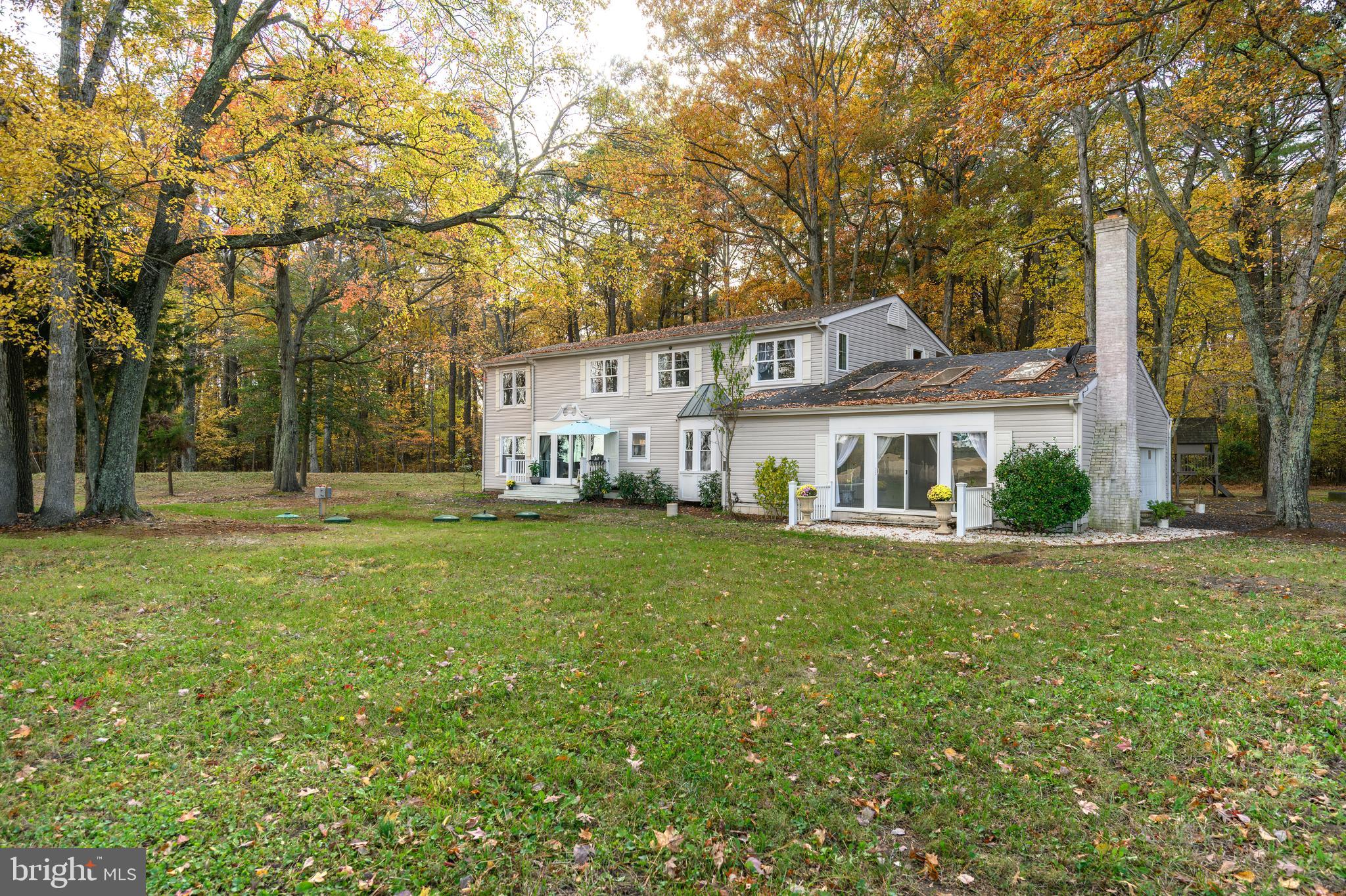 Enjoy the serenity of country living just minutes from both downtown Easton and Cambridge! This spacious four bedroom, two and a half bath home offers over 3,400 square feet of living space and sits on nearly an acre (.96+/-) with covered front porch and nice rear deck with views of open fields/farmland. This solid house offers a comfortable layout on both levels and it's perfect for both everyday living and entertaining. The main level features a large two story foyer with beautiful staircase, large family room, open kitchen with breakfast nook and beautiful bay window, separate dining room, and sunroom with vaulted ceiling, skylights, wood burning fireplace and beautiful open views of farmland.  Upstairs, the primary suite is like a private retreat with it’s own bathroom, walk in closet and balcony.  Three additional bedrooms and bath complete the second floor.  Attached two car garage with private circular drive surrounded by mature trees for privacy. The home features a new roof (2025), a new well, new septic system (2025) and new HVAC (2022). Within a mile of Ferry Point Marina, Waterfront State Park and Choptank Fishing Pier. Close to all of downtown Trappe/Easton/Cambridge shopping, restaurants, churches and medical facilities.