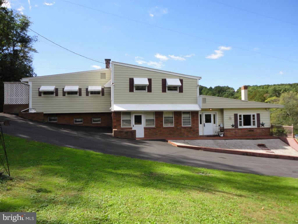 This one of a kind home needs a new family! There is over 5,000sf of living space including in law quarters! Highlights include 5+ bedrooms, great/recreation room with 20' custom built wet bar & brick fireplace, florida room with hot tub, and relaxing enclosed porch. Separate efficiency apartment with separate entrance on main level. 1 car garage. Exterior features a 50' pavilion, custom brick patio and pool! Great family home!