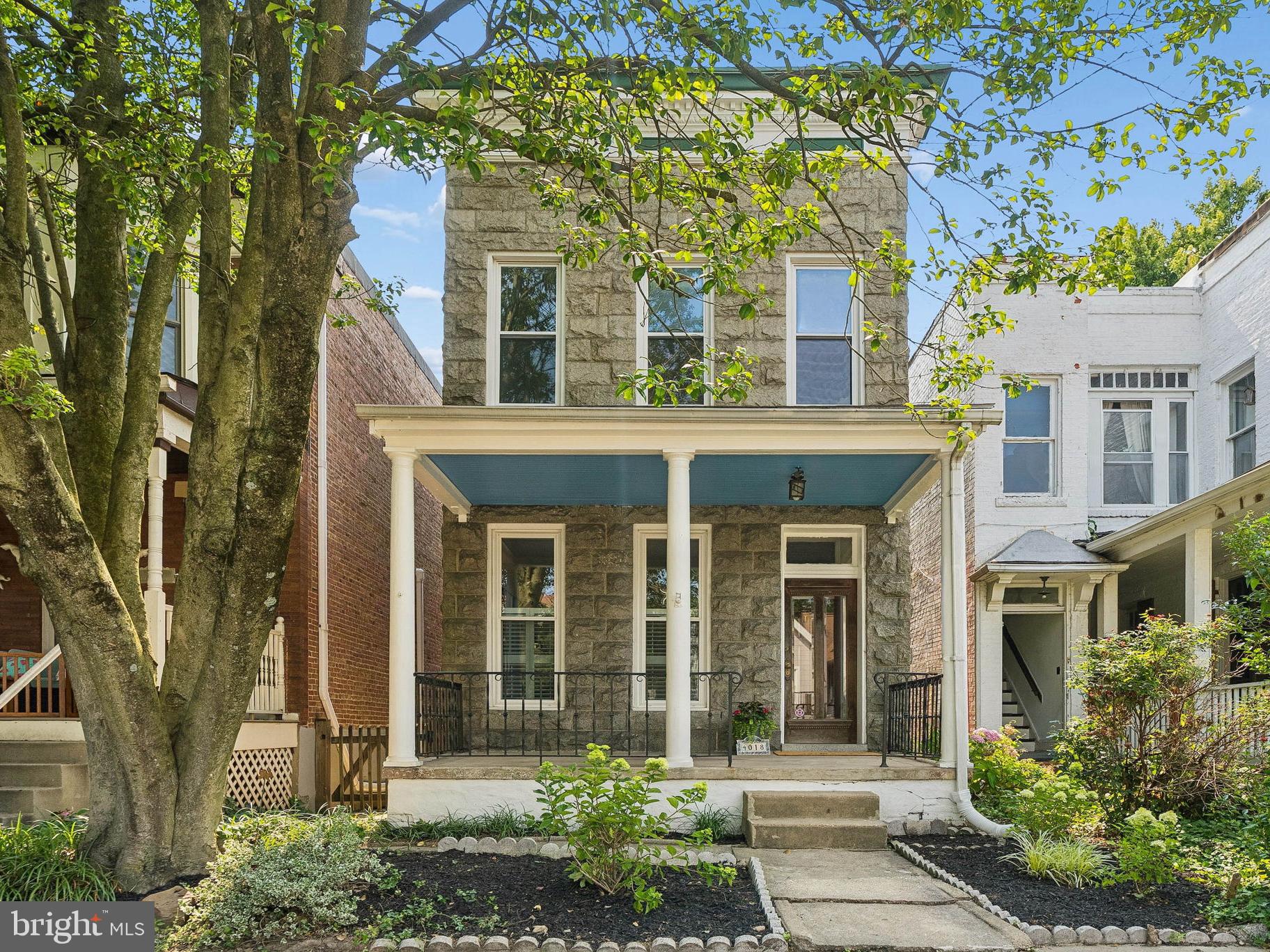 Rich in character and ideally located between Hampden and Roland Park, this charming historic home has been thoughtfully updated while preserving its original appeal. The recently painted covered front porch, complete with floor-to-ceiling windows, pays homage to Baltimore's historic roots while creating a warm and inviting first impression. Step inside to a home that's been freshly painted throughout. The main level showcases beautiful inlaid hardwood floors, classic pocket doors, and elegant French doors that highlight the home's original craftsmanship. The spacious dining room features a charming circular bump-out and large, sun-filled windows, creating the perfect setting for everyday living or entertaining. Continue into the inviting family room, where oversized windows and a decorative fireplace add warmth and character. The kitchen was completely renovated in 2026 and beautifully balances modern style with the home's historic character. A stunning tin-stamped ceiling serves as a focal point, while crisp white cabinetry, Quartz countertops, a ceramic tile floor and backsplash, and stainless steel appliances—including a GE gas range and microwave—provide both beauty and functionality. Just beyond the kitchen, a spacious Butler's Pantry offers additional storage and workspace, leading to a convenient half bath and a rear deck overlooking the brick paver patio and fully fenced backyard. Upstairs, the primary suite features a spacious, newly carpeted walk-in closet with two windows. All three bedrooms offer hardwood floors and abundant natural light, while the center bedroom showcases a distinctive curved bump-out that adds architectural interest. The full bath reflects the home's timeless character with an antique transomed door, classic wainscoting, black-and-white tile flooring, a tiled tub/shower surround, and a new exhaust fan (2026). The basement provides abundant storage, a laundry area complete with a washer, dryer, and utility sink, plus a new exterior door leading to the backyard. Ideally located just moments from The Avenue's boutiques, restaurants, galleries, and local favorites, while also enjoying easy access to the charm of Roland Park, nearby parks, public transit, and I-83 and I-695, this home offers the best of city living. Whether you're drawn to the home's timeless character, its thoughtful modern updates, or its exceptional location, this one-of-a-kind home is ready to welcome you.