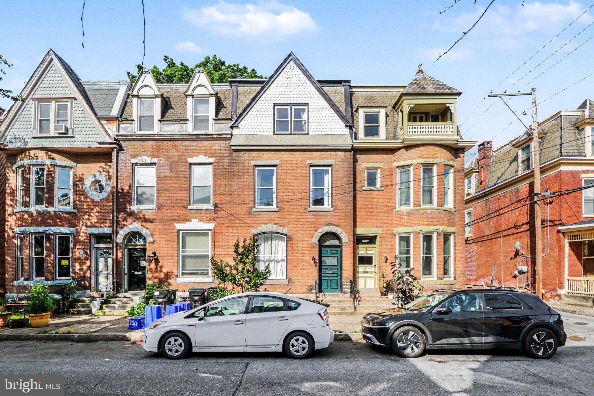 This 4-bedroom, 2.5-bath Victorian rowhouse has serious charm and the updates to back it up. The main floor is open with high ceilings, a decorative fireplace, and great natural light. A half bath is conveniently located just off the dining room. Toward the rear, the kitchen has been fully updated with navy cabinetry, quartz countertops, a butcher block island, stainless steel appliances, and a gas range with a proper hood vent. Walk straight out to a private, fenced brick backyard.  It is a great outdoor space in the middle of the city. The second floor has three bedrooms, a full bath with in-unit laundry, and an enclosed rear porch that works well as a home gym, office, reading room, or just extra living space. The third floor is its own private world:  a spacious bedroom, an ensuite full bathroom and a large walk-in closet with custom built-in shelving. If you want your own space away from the rest of the house, this is it. Central A/C, full unfinished basement for storage, and a location you can actually walk from. 1710 Green Street puts you steps from the Broad Street Market, Little Amps, and everything the neighborhood has to offer.