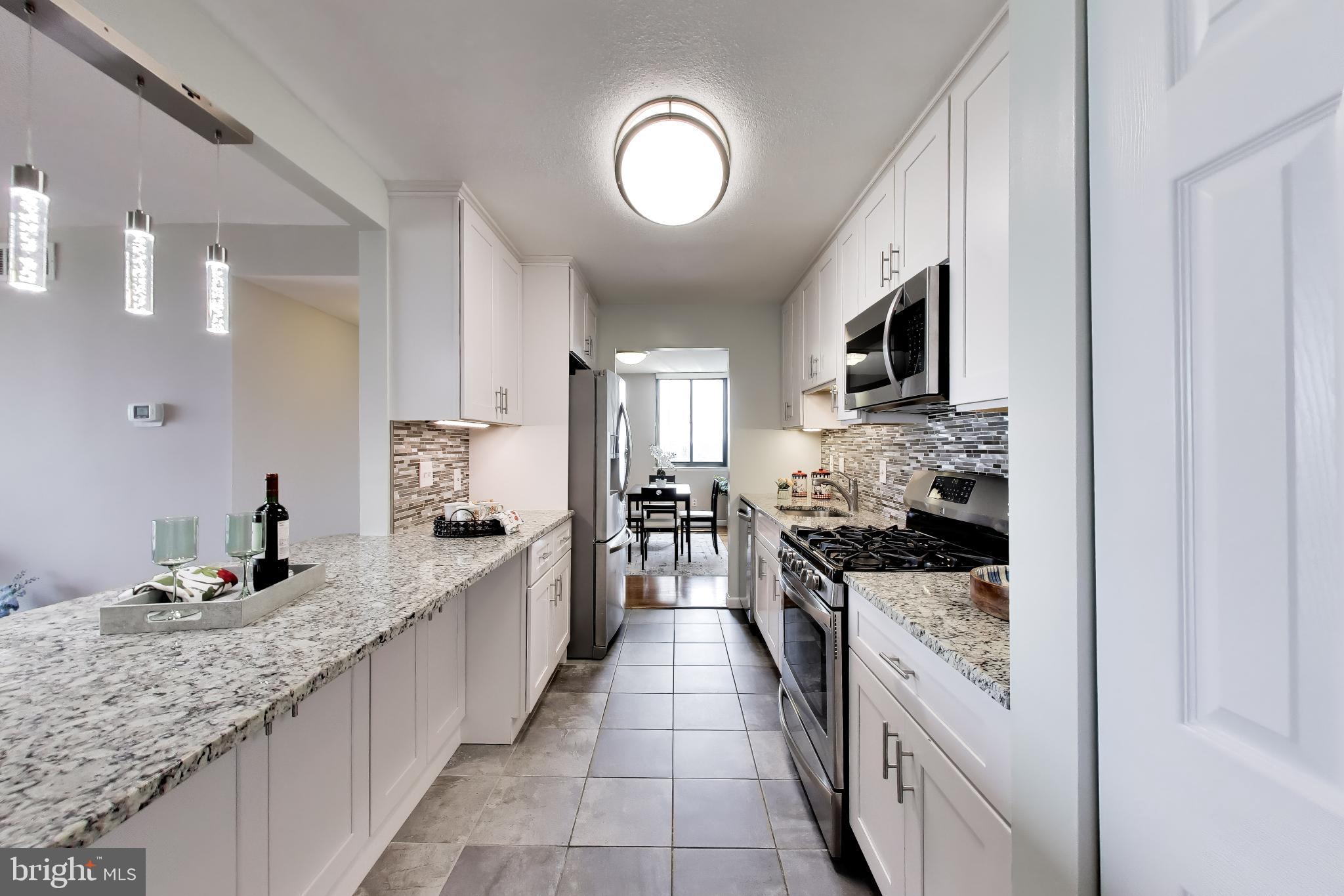 Welcome to The Adams House at Americana Centre in the heart of Rockville, where comfort, convenience, and full-service living come together. This bright and inviting 2-bedroom, 2-bath condominium offers an ideal opportunity to enjoy a walkable urban lifestyle just steps from Rockville Metro, Rockville Town Center, restaurants, shopping, the Montgomery County Library, Regal Movie Theatre, Starbucks, and Trader Joe’s. With quick access to Routes 270, 370, 495, and 355, commuting and everyday errands are exceptionally convenient. The Rockville Farmer's Market is across the street! Inside, this condo features a bright, open layout with flexible living and dining space, abundant natural light, and a private balcony overlooking Rockville scenery. The galley kitchen features stainless steel appliances, granite countertops, gas cooking, porcelain tile flooring, glass tile backsplash, generous cabinet and pantry storage, and a pass-through to the living room. Spacious bedrooms, 3 walk-in closets, updated bathrooms, hardwood floors, and fresh paint are among the many thoughtful touches that add comfort, function, and move-in-ready appeal.

Residents of Americana Centre enjoy a strong sense of community and an impressive collection of amenities, including 24-hour front desk service, concierge and package receiving, a recently renovated lobby, hallways, and elevators, outdoor pool, fitness center, community or party room, picnic areas with grills, on-site maintenance staff, and secure entry features such as a lobby desk and intercom system. Your condo includes a reserved parking space in the garage. There is ample guest parking.  The condo fee includes all utilities, amenities, services, and laundry, making ownership simple and low-maintenance.

Whether you are a professional, commuter, investor, or buyer seeking a low-maintenance home in one of Rockville’s most accessible locations, this condominium offers the perfect blend of lifestyle and value. Enjoy full-service amenities, unbeatable Metro access, nearby dining and entertainment, and the convenience of utilities included in the condo fee. Move-in ready and easy to appreciate, this Americana Centre condo delivers comfort, convenience, and community in the center of it all.