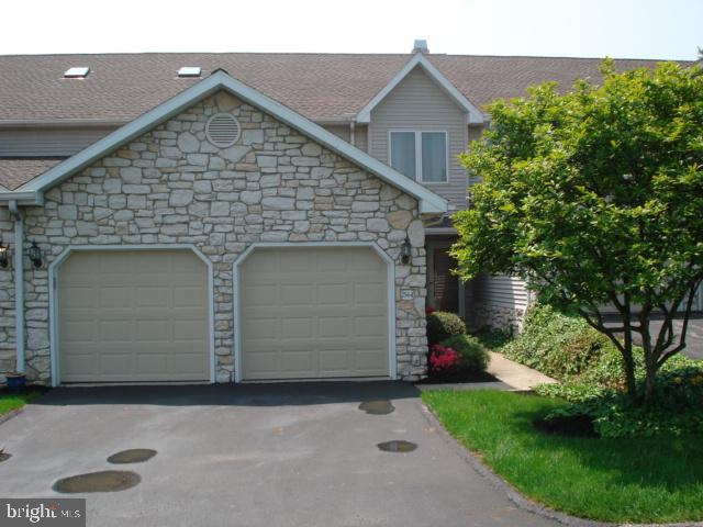 Condo living overlooks wooded hillside with seclusion, nature & wildlife!  Custom features incl awesome walk out lower level family rm with stone fireplace, hardwood floors, granite counter tops and popular sun room walks out to deck with awning.  Open floor plan offers 2nd fp, skylights, cathedral  ceiling, loft and master suite with deluxe bath and walk in.  2 car garage has pull down to additional storage above, cul-de-sac location with nearby guest parking, new roof and home warranty.  Experience the Heritage Hills maint free lifestyle convenient to I83, shopping, restaurants, golf & fitness venues!