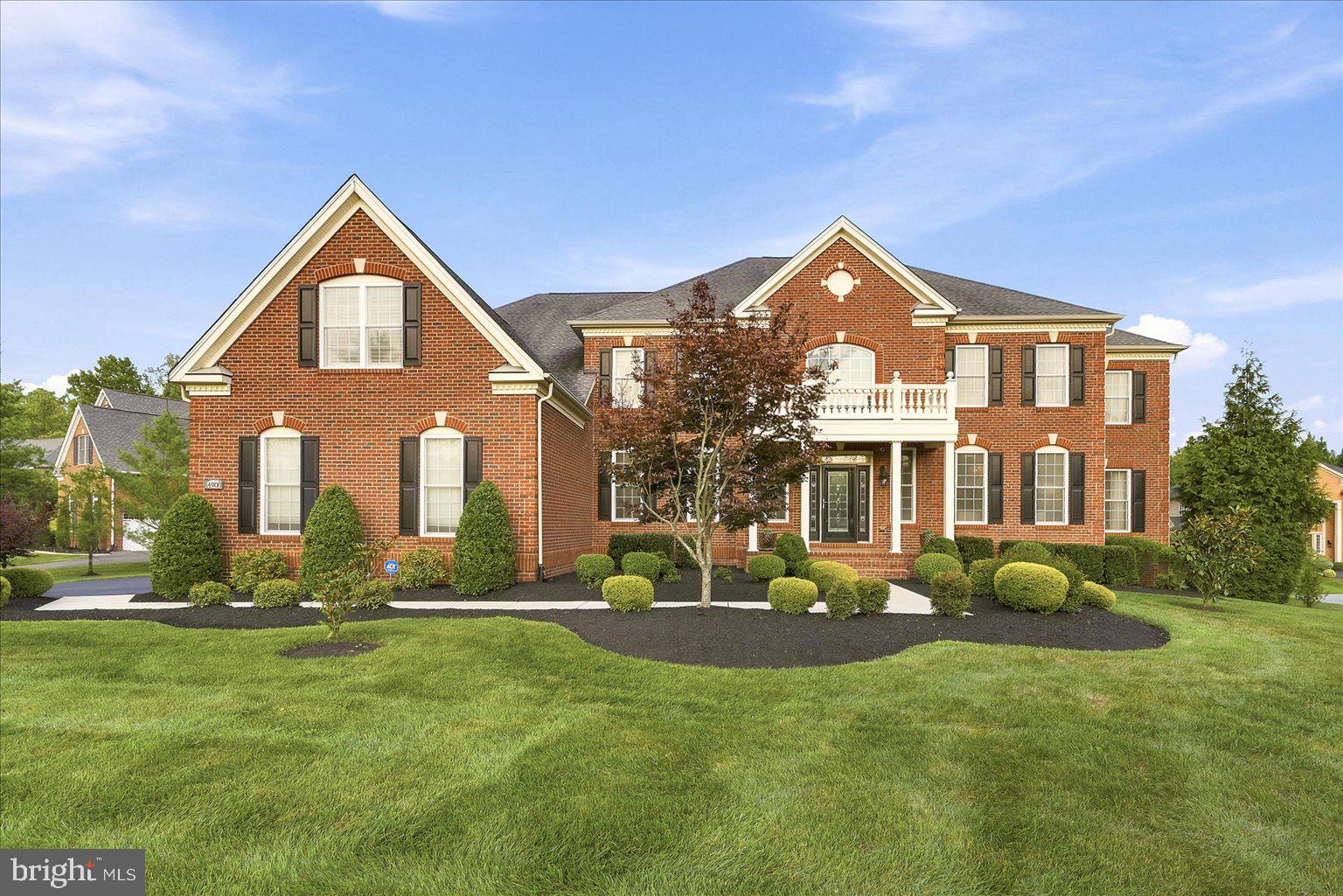 Behind the gates of the prestigious Oak Creek golf course community, this extraordinary custom estate offers a rare combination of timeless architecture, exceptional craftsmanship, and over half a million dollars in carefully curated upgrades. Designed to elevate everyday living while creating an unforgettable setting for entertaining, every space reflects an uncompromising attention to detail. A dramatic marble foyer introduces the home with a sweeping double curved staircase, custom iron railings, and a designer chandelier equipped with an automated lift, setting the stage for the elegance that unfolds throughout. Rich engineered hardwood flooring, custom lighting, and thoughtfully selected architectural details create a warm, sophisticated ambiance that is both grand and inviting. At the heart of the home, the gourmet kitchen is appointed with premium Monogram appliances, upgraded 42-inch custom cabinetry, and an expansive walk-in pantry. It opens effortlessly to the soaring two-story great room, creating a gathering space equally suited for intimate evenings or elegant celebrations. Natural light fills the sun room and the expanded Naples room through upgraded windows and sliding glass doors, seamlessly connecting the interior to beautifully designed outdoor living spaces. The screened porch offers a peaceful retreat, while the expansive deck and patio, complete with a firepit and whole-home Sonos audio system, provide an exceptional backdrop for outdoor entertaining throughout the seasons. Underground wiring for a future generator offers added peace of mind. A private elevator connects all levels of the residence, blending luxury with everyday convenience. The primary suite is designed as a true sanctuary, featuring its own sitting room, a private fireplace, and a beautifully appointed spa-inspired bath highlighted by a custom oversized shower, separate soaking tub, and refined finishes. The upper level has been thoughtfully expanded to include a spacious bonus suite with two additional full baths, providing exceptional flexibility for a variety of lifestyle needs. The lower level continues the home's impressive design with a private theater, custom entertaining bar, exercise room, fireplace, and expansive recreation spaces that invite everything from quiet evenings to unforgettable celebrations. Every improvement reflects a commitment to quality, including upgraded designer lighting throughout the residence, enhanced flooring, custom fireplaces, premium windows and doors, expanded living areas, and countless architectural enhancements that distinguish this home from ordinary new construction. Residents of Oak Creek enjoy access to a championship golf course, elegant clubhouse, swimming pool, tennis courts, fitness facilities, and scenic walking trails, all while remaining conveniently connected to shopping, dining, parks, major commuter routes, Washington, District of Columbia, Annapolis, and Baltimore. This is more than a residence. It is a home designed for gracious living, effortless entertaining, and creating lasting memories for generations to come. Experience the exceptional craftsmanship, thoughtful design, and distinctive lifestyle that make this offering truly one of a kind. Photos may be virtually staged