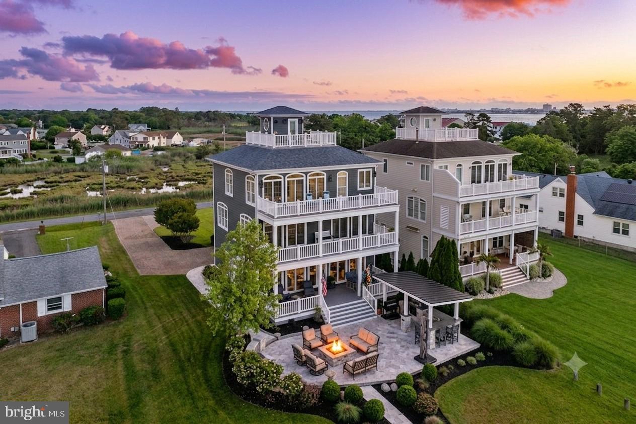 Where do you even begin with a property like this?

Let's start at the very top.

Perched above it all is the extraordinary Pilot House rooftop retreat, offering breathtaking 360-degree views that stretch across the entire Ocean City skyline, the Atlantic Ocean, Assateague Island, and beyond. Imagine starting each day with spectacular sunrises and ending it with vibrant coastal sunsets. From the Air Show to the White Marlin Open send-off, you'll enjoy front-row seats to some of Ocean City's most iconic events—all from the comfort of your own private rooftop sanctuary.

But this home is far more than just an incredible view.

Let's paint the picture from the top down.

Friends arrive and immediately ask, "Can we see the rooftop?" You open the elevator, ride effortlessly to the third floor, then ascend the spiral staircase to the Pilot House. There, an expansive rooftop balcony and patio reveal panoramic views of your entire 11-mile barrier island. It's a perspective few ever experience and one you'll never tire of.

After taking in the views, head back down to the exceptional outdoor living space designed by Wes Novelli. Whether you're enjoying a freshly made Orange Crush, relaxing with a cold beer, or simply soaking in the surrounding nature and privacy, this outdoor oasis is designed for unforgettable gatherings and peaceful evenings alike.

The entire third floor is dedicated to an impressive Primary Retreat. This private sanctuary features a spacious bedroom with room for a sitting area, home office, or Peloton, along with a cozy fireplace for year-round comfort. The custom-designed walk-in closet includes a dressing area and abundant natural light. The luxurious primary bath offers a soaking tub, oversized shower, and bright, airy atmosphere. Completing the retreat is a stunning private deck spanning the full width of the home.

The second floor is designed to comfortably accommodate family and guests. An oversized hallway includes a convenient beverage station with built-in refrigerator and storage. Three spacious bedrooms are located on this level. Two enjoy eastern exposure and access to a large deck, sharing a beautifully appointed Jack-and-Jill bath. The third bedroom offers expansive western views and functions as a junior primary suite.

The gourmet kitchen is a chef's dream, featuring induction cooking, custom granite countertops, abundant cabinetry, and quality finishes throughout. Thoughtful details, including soft-close cabinetry, ensure both style and functionality.

On the first floor, you'll find a spacious great room with fireplace, dining area, lounge space, oversized powder room, and a side-entry two-car garage. Just outside, the professionally designed outdoor entertaining area features a full outdoor kitchen, extensive lighting, and a firepit—perfect for hosting family and friends throughout every season.

And then there's the waterfront lifestyle.

The private dock is exceptional, accommodating a boat on a lift, multiple jet skis, an additional spot for your guests, and offering convenient lighting for evening use. A dedicated kayak launch makes it easy to explore the surrounding waterways whenever adventure calls.

Perhaps one of the best-kept secrets is the location itself. Situated in West Ocean City, this property offers the perfect balance of privacy and convenience. Enjoy easy access to marinas, restaurants, shopping, and all that Ocean City has to offer, while being just a 1.9-mile walk or bike ride to the world-famous Boardwalk and beach. Best of all, you'll benefit from no Ocean City town taxes and the property is not located within a flood zone requiring flood insurance.

A home with views, luxury, privacy, boating access, and exceptional outdoor living is a rare find.

Schedule your private tour today. Property is owner occupied; 24-hour notice is respectfully requested.