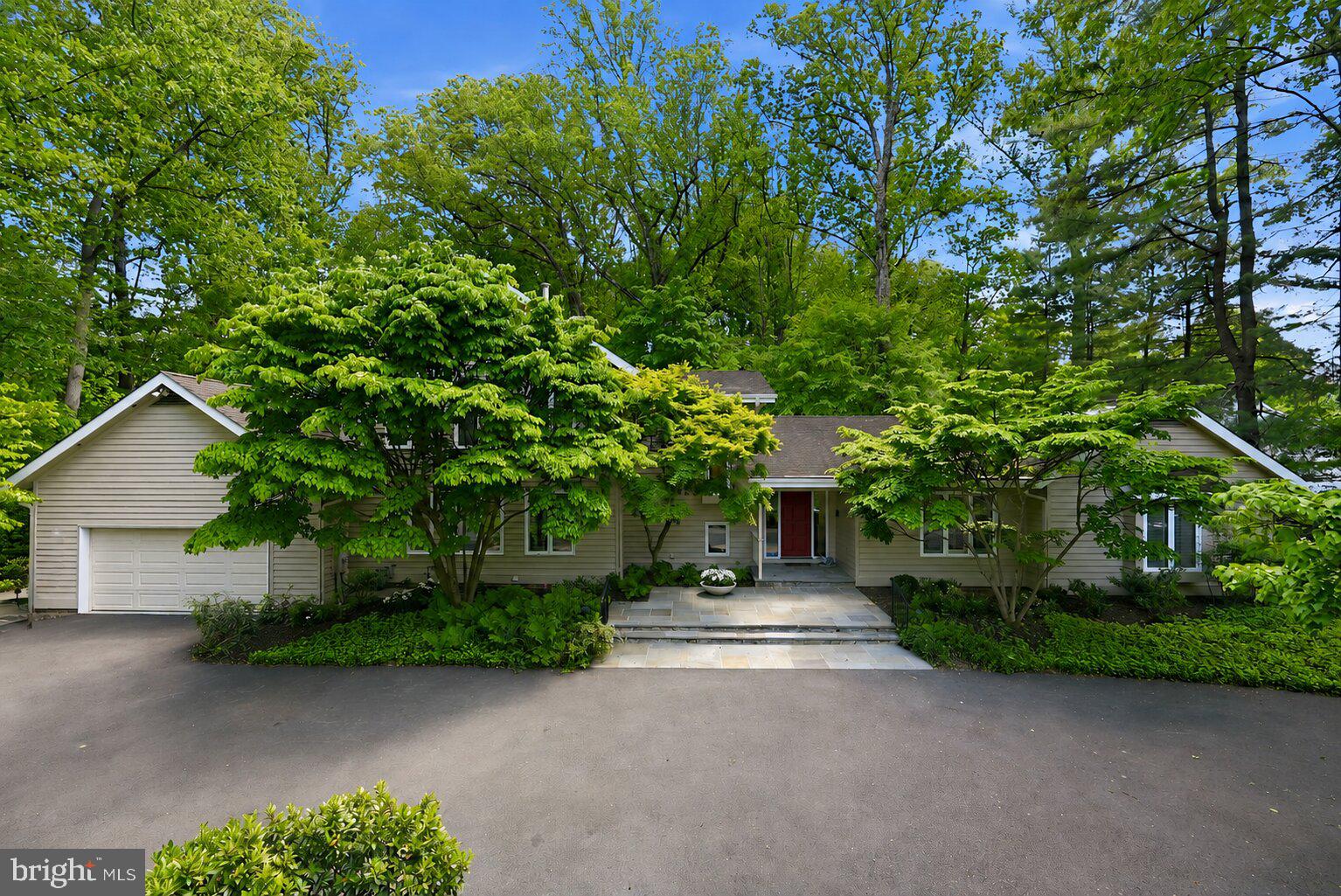 Nestled on a premier wooded lot on a quiet street, 11815 Beekman Place presents a rare opportunity to own a spacious and beautifully designed residence in one of Potomac’s most sought-after neighborhoods. Built in 1982, this home was interior designed by Thomas Pheasant, and will impress you with its mature trees and lush landscaping. This exceptional property offers privacy, scale, and timeless appeal on nearly an acre of land.

A semi-circular driveway and stately exterior create a striking first impression, while the oversized two-car garage with epoxy flooring adds both functionality and style. Inside, the home offers an expansive and thoughtfully designed layout featuring four bedrooms and four full bathrooms, including a highly desirable first-floor primary suite ideal for both comfort and convenience.

The main level is filled with natural light, highlighted by dramatic floor-to-ceiling windows and multiple sliding glass doors that seamlessly connect the indoor living spaces to the surrounding natural setting. Designed for both everyday living and entertaining, the home features generous living and dining areas, a dedicated first-floor office, and a spacious laundry room conveniently located on the main level. At the heart of the home, the eat-in kitchen offers abundant workspace and storage with a large center island, double ovens, high-end stainless steel appliances, and plenty of room for casual dining and gathering.

The upper level features three sizable bedrooms, and two full bathrooms. There is a second ensuite that could be a second primary bedroom. Both upper level bathrooms were just completely renovated down to the studs and feature sleek white and grey tile, oak vanities, brushed nickel delta finishes.
The lower level provides exceptional flexibility with multiple recreation spaces perfect for a home gym, playroom, media room, or guest retreat. There is also the opportunity to easily add an additional bedroom, creating even more versatility for future needs.

The expansive backyard setting offers a peaceful retreat with endless possibilities for outdoor entertaining, recreation, or simply enjoying the privacy and beauty of the wooded surroundings.

Ideally located within the highly regarded Churchill school cluster and just minutes from Country Glen Swim and Tennis Club, Potomac Village, parks, golf courses, major commuter routes, and premier shopping and dining, this home combines tranquil suburban living with unmatched convenience. Make this your home today!