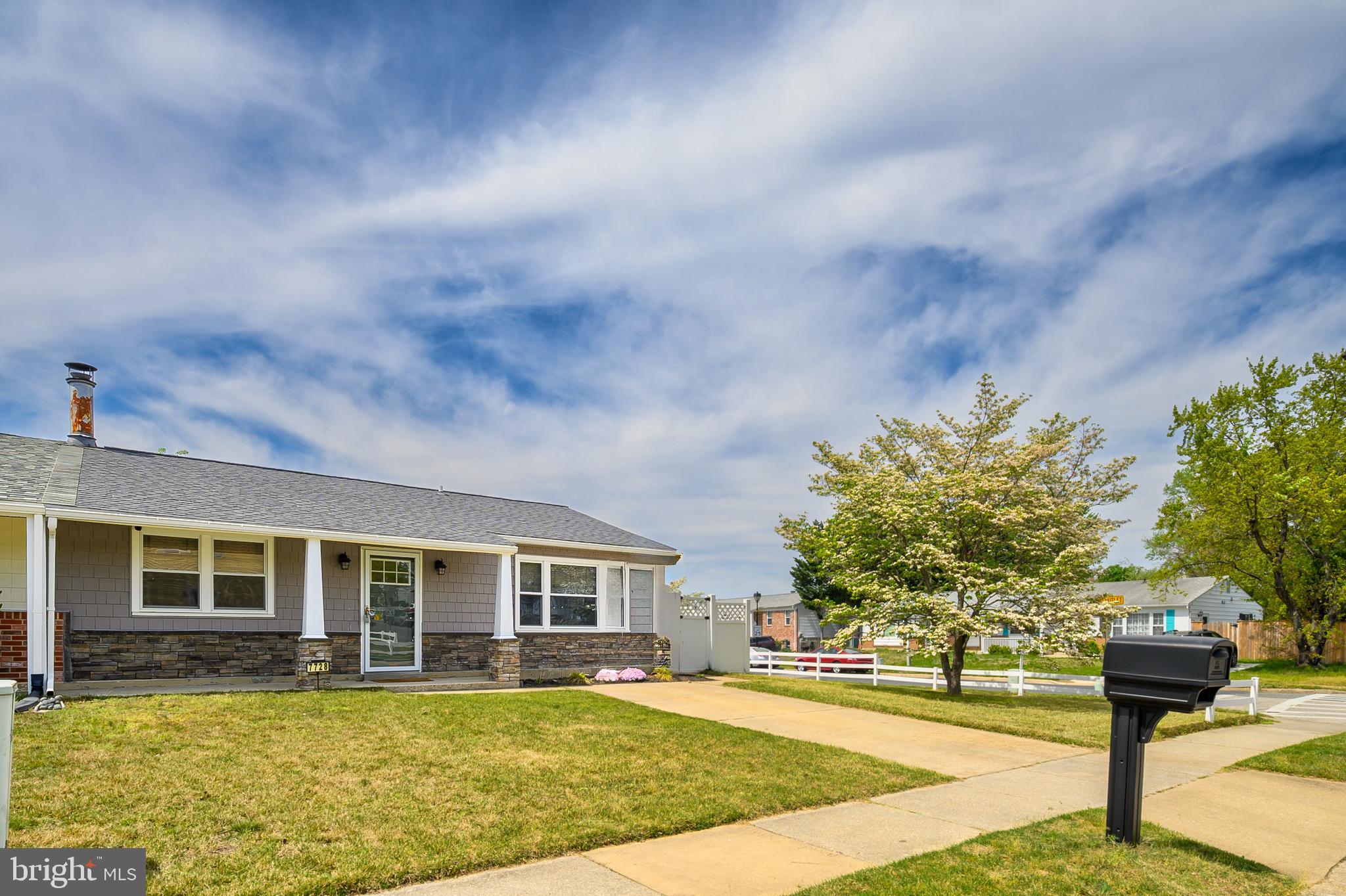 Renovated one level living duplex with an oversized detached 2 car garage! This gorgeous rancher was beautifully updated in 2021 with  new siding, formed stone exterior, new front door, new roof (2020), new HVAC (2017), Kitchen and bathroom new in 2017. Durable laminate flooring throughout. The kitchen features 42" cabinetry with wine storage, quartz countertops, subway tile backsplash, updated appliances including concealed, space saving stackable new washer and dryer (2023). Enjoy cold winter nights by the wood burning fireplace. The full bath has classic, yet stylish appeal with the tile choices, including tiled shower surround, white vanity with solid surface top, and tiled floor. The oversized garage is a huge bonus space for storage, workshop, etc. The corner lot provides two driveways giving ample parking for homeowner's and guests. The partially covered deck gives additional outdoor entertaining space.