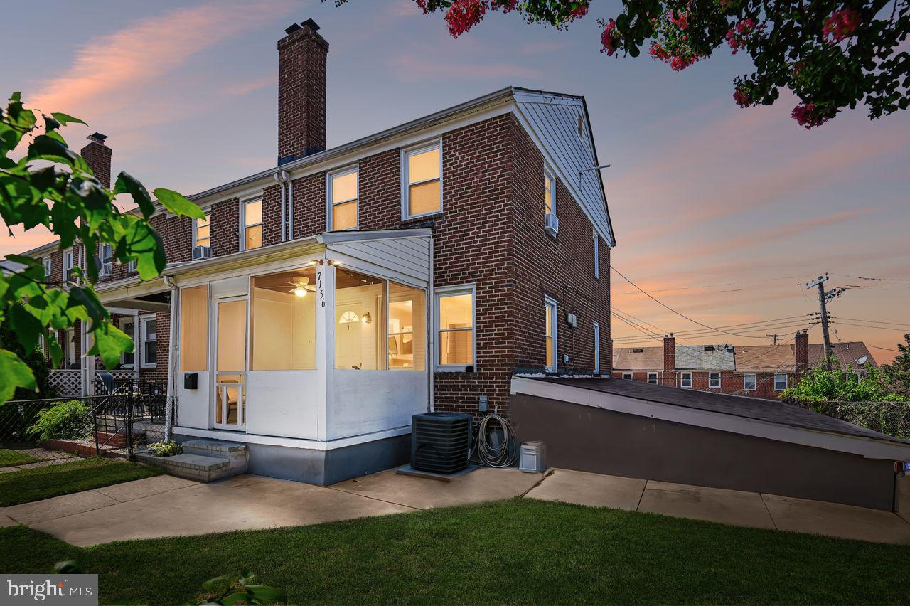 Welcome home to this charming end-of-group brick townhome in the sought-after Eastwood community. Situated on an one of the largest lots in the neighborhood, this well-maintained residence offers 4 bedrooms, 2 bathrooms, and the rare convenience of a detached 2-car garage. Inside, you'll find beautiful wood flooring, a spacious living and dining area, an eat-in kitchen, and flexible living space with a main-level bedroom option. The lower level provides additional room for recreation, a home office, or guest accommodations, complete with walk-out access to the backyard.

Step outside to enjoy the generous fenced yard with mature landscaping, covered front porch, and a rooftop patio perfect for entertaining, gardening, or relaxing outdoors. Conveniently located near shopping, dining, parks, major commuter routes, and minutes from Baltimore's waterfront attractions, this home combines space, functionality, and value.  New roof in 2023 and LVP flooring in the lower level in 2025, with new blinds and fresh paint throughout the interior.  Don't miss this opportunity to own a move-in-ready end-unit with extra yard space and garage parking in Eastwood.