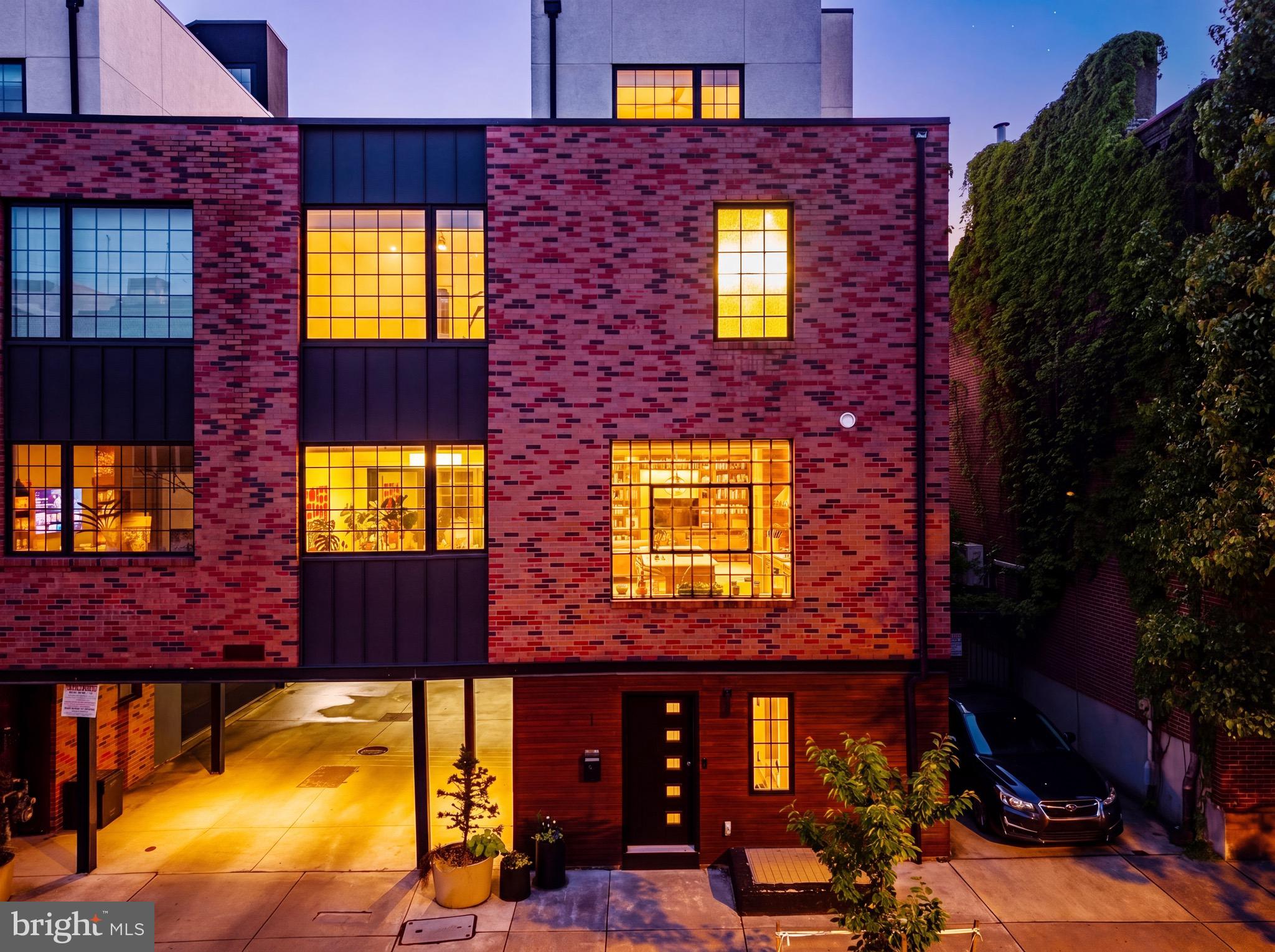 You can truly have it all in Fishtown - welcome to Shack8! This elevated corner carriage home offers over 3,000 square feet of refined living, rare 2-car garage parking, remaining tax abatement, multiple outdoor spaces, and a seamless blend of architectural design and everyday functionality, all set on one of the neighborhood’s most serene, tree-lined blocks. A welcoming foyer introduces the home with striking herringbone hickory flooring, custom-crafted storage, and a thoughtfully redesigned powder room featuring a live-edge walnut vanity. The attached two-car garage, an exceptional find, comfortably accommodates SUVs and includes integrated storage and a bike rack. The finished lower level provides versatile space ideal for a media room, gym, office, or guest suite. The main living level is a true statement. Anchored by a floating steel-and-wood staircase and a dramatic double-height cypress feature wall, finished in the shou sugi ban technique, the space evolves beautifully with natural light. Expansive windows on three exposures flood the home, while a custom walnut-and-ash built-in adds warmth and texture. The chef’s kitchen is equally impressive, featuring walnut-veneered cabinetry, quartz countertops, and a premium Thermador appliance suite. A steel-framed awning window frames leafy views, while the adjoining dining area opens seamlessly through La Cantina doors to a professionally designed deck complete with a built-in grill, fire pit, and automated irrigation. Upstairs, the primary suite offers a serene retreat with dual exposures, a spacious walk-in closet, additional shoe storage, and a spa-quality bath with double vanity, oversized shower, and freestanding soaking tub. A secondary bedroom and full bath complete this level. The top floor hosts a private third bedroom suite with custom built-ins, an ensuite bath, and access to an expansive roof deck with sweeping skyline views. Built by Kassis Ventures, this residence reflects a thoughtful commitment to design, craftsmanship, and livability. Located within the Alexander Adaire school catchment and just moments from the Market-Frankford Line, Center City, and Fishtown’s most celebrated destinations—Suraya, Kalaya, LMNO, Wm. Mulherin’s, Pizzeria Beddia, Laser Wolf, Penn Treaty Park, and the Delaware River waterfront, this is a rare opportunity to experience modern luxury in one of Philadelphia’s most dynamic neighborhoods.