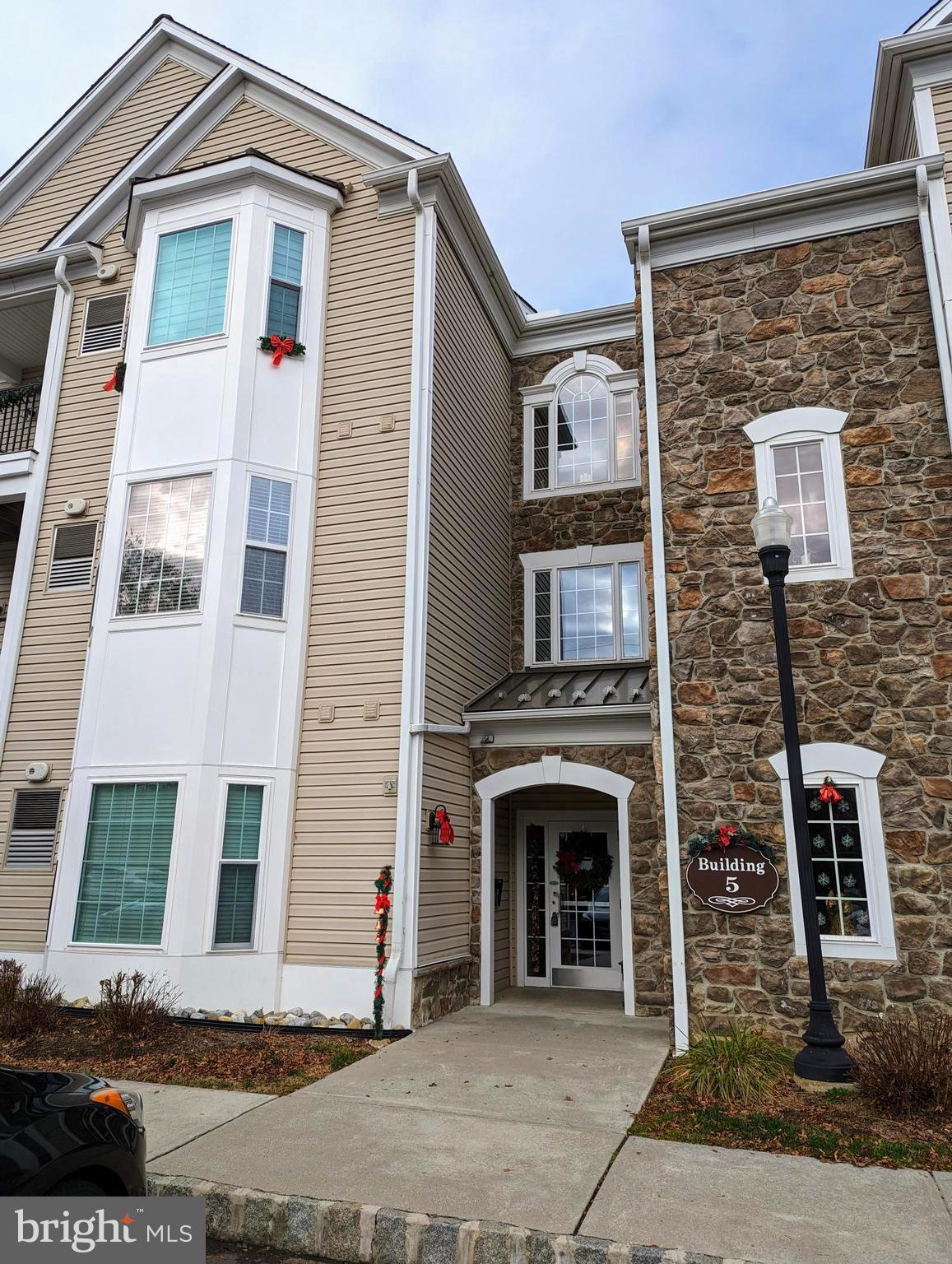 Welcome to Traditions at Ridley Creek, a coveted and established lifestyle community! This lovely and established 55 + community has an assigned parking space in front of building 5, storage cage, a gorgeous clubhouse with a library/game room, fitness room, party room with cathedral ceilings, fireplace, full kitchen and an outdoor covered patio area to entertain.  The condo is on the 2nd level with a balcony facing a lovely stone wall and open space. This is only the 2nd owner to own the condo with one occupant. Entry the security main door into a wide hallway follow to the elevator to the 2nd floor lobby. There are 4 condos per floor. Enter the spacious condo with updated luxury plank flooring into the foyer where you will find a coat closet and double wide laundry closet. The layout is open, the dining room is upgraded with a chair rail and crown molding. The kitchen offers stainless steel appliances, garbage disposal, dishwasher, microwave, gas range, ample cabinets and lots of counterspace for cooking prep. The kitchen is open to the living room with a ceiling fan and sliders to the balcony allowing natural sunlight into the condo. The view from the balcony is perfect to relax and enjoy the sunrise and a short walk to the clubhouse. The main bedroom suite has a bay bump out, a large double wide closet, linen closet and a spacious full bath with a walk-in shower with bench. As you tour the condo you will find the 2nd bedroom, den and 2nd full bath with a tub. The location is convenient, Brookhaven Borough is a wonderful community with year-round activities for all ages to enjoy including a senior Holiday luncheon, several shopping centers, one with a Starbucks, multiple eateries, multiple grocery stores. Close drive to a R3 commuter train to Center City Phila, Philadelphia International Airport, the local Linvilla Farm, hiking trails, N/J and DE.  Quick settlement available.